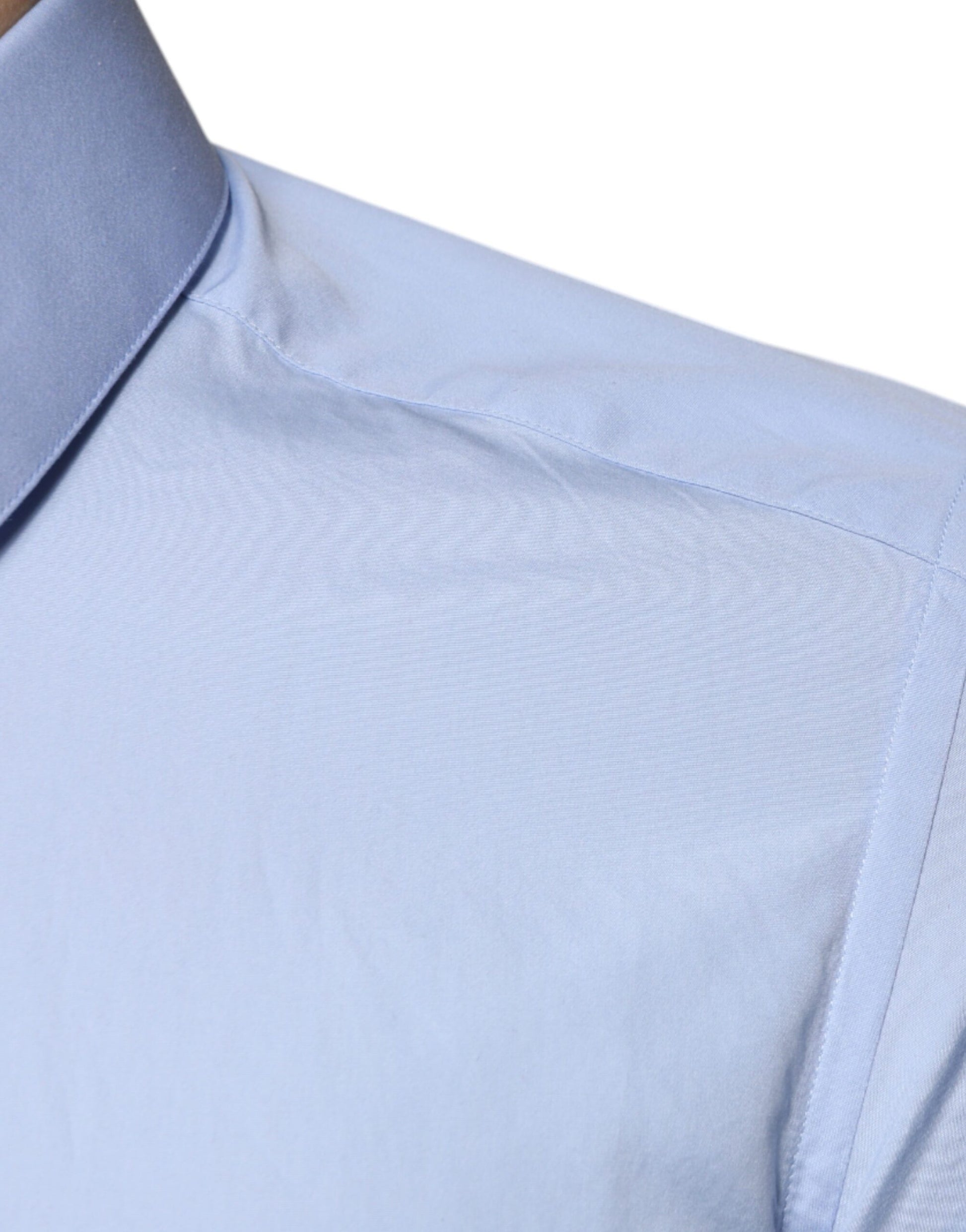 A light blue cotton dress shirt with a slim fit and gold detailing