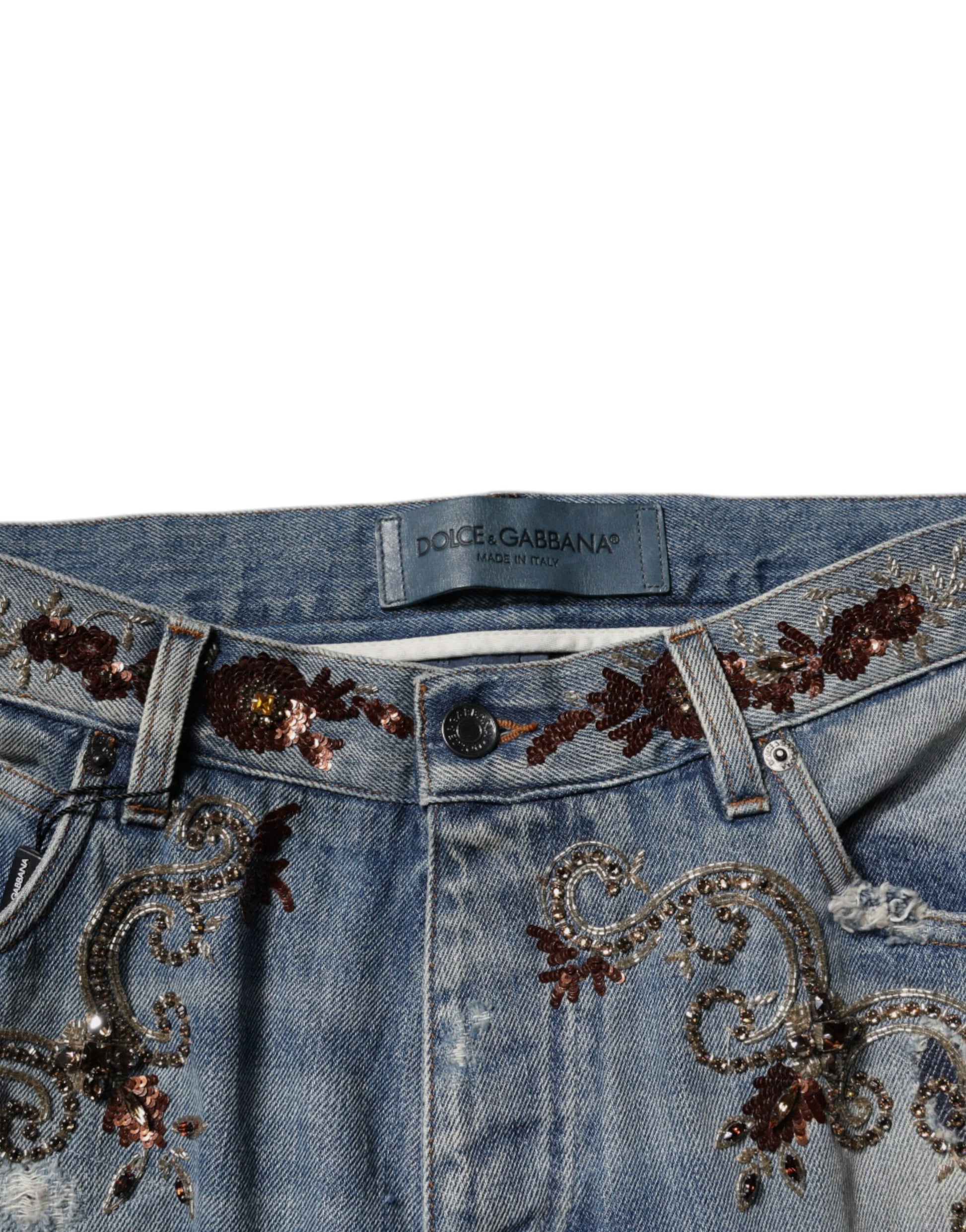 Blue denim jeans with embroidered floral design on waistband