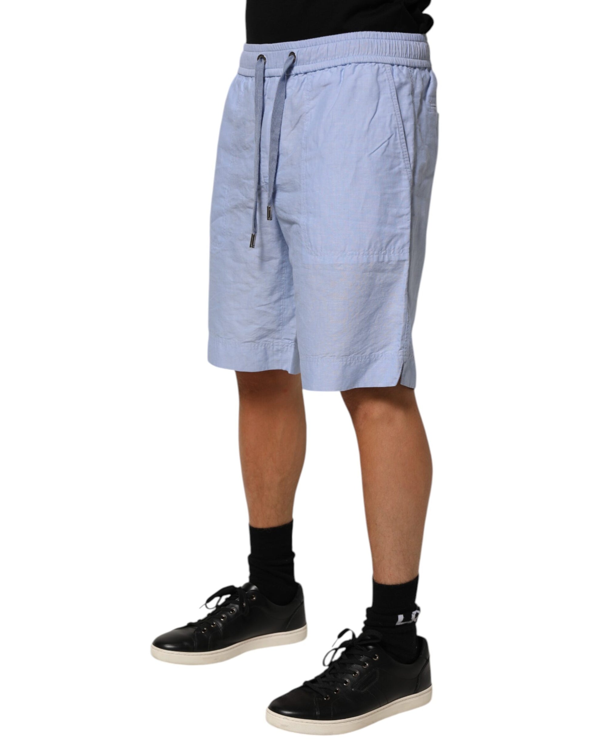 Man wearing blue shorts and black shoes