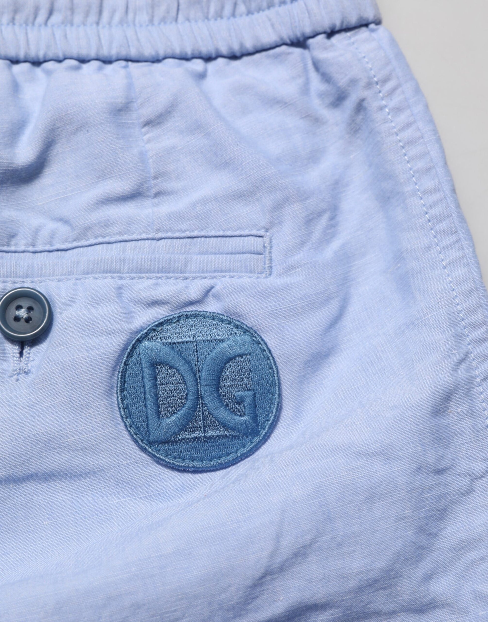 Blue shorts with a logo on the left leg