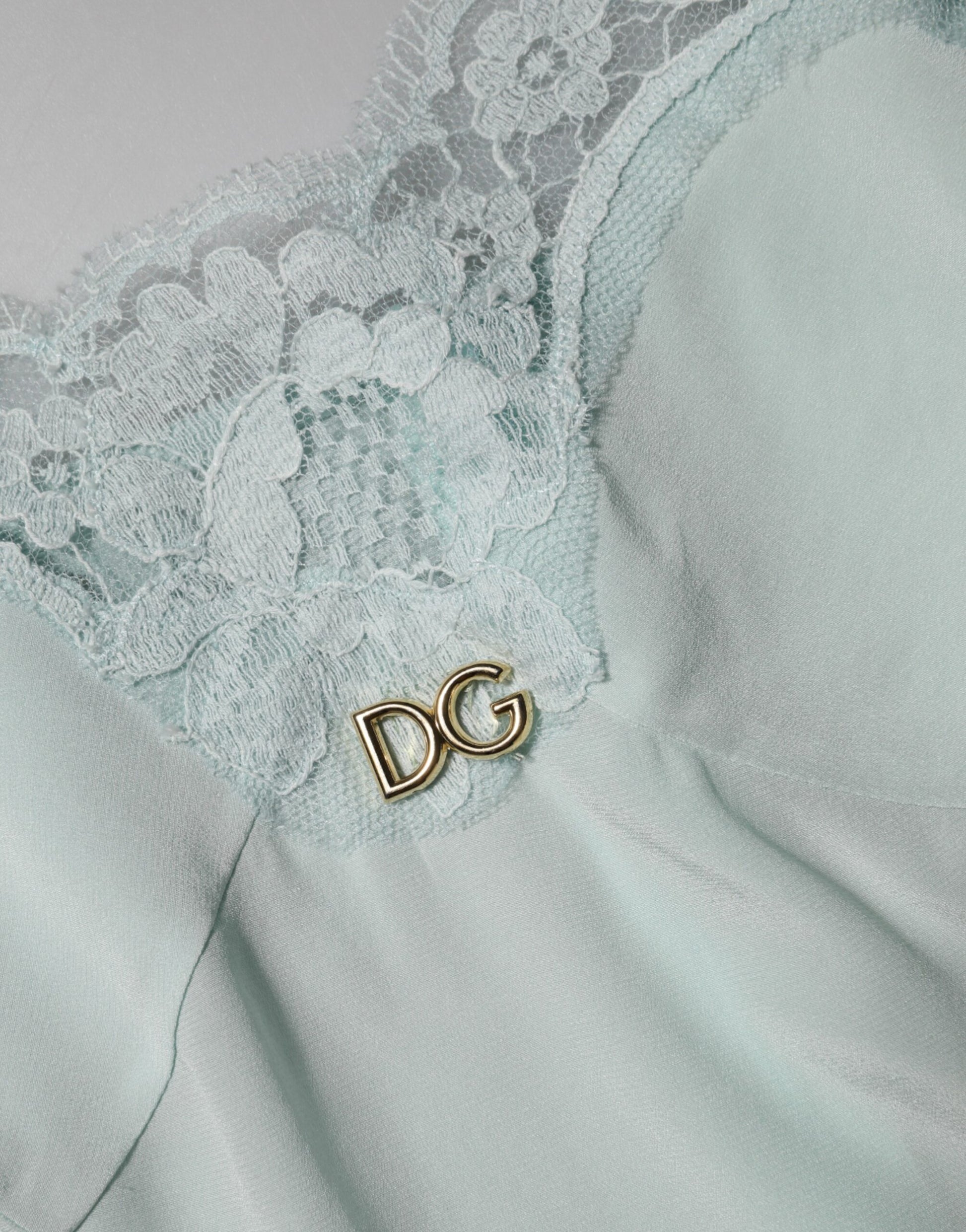 A light blue silk lace midi bodycon slip dress with a gold D&G button