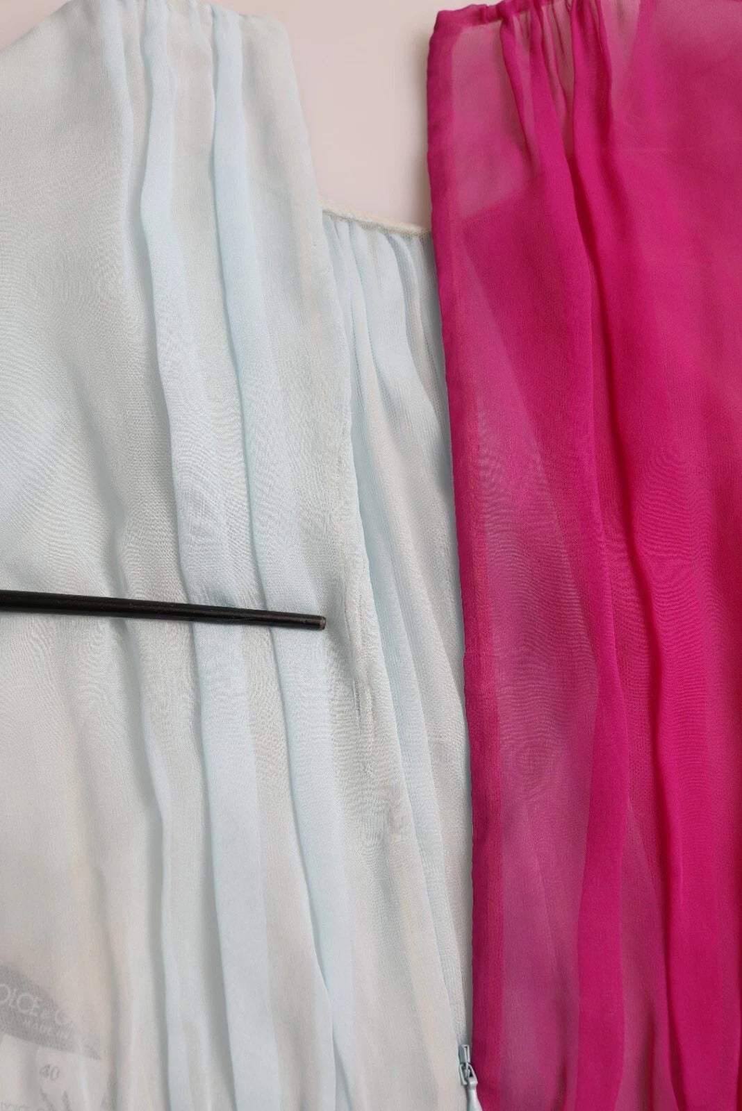 A light blue silk midi dress with a two tone design, featuring ruffled sleeves and a pink scarf
