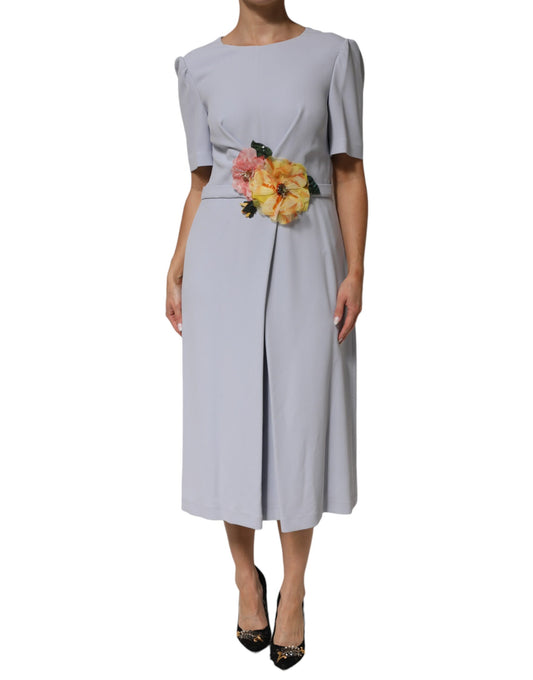 A long sleeve dress with a floral applique on the bodice and a flared skirt