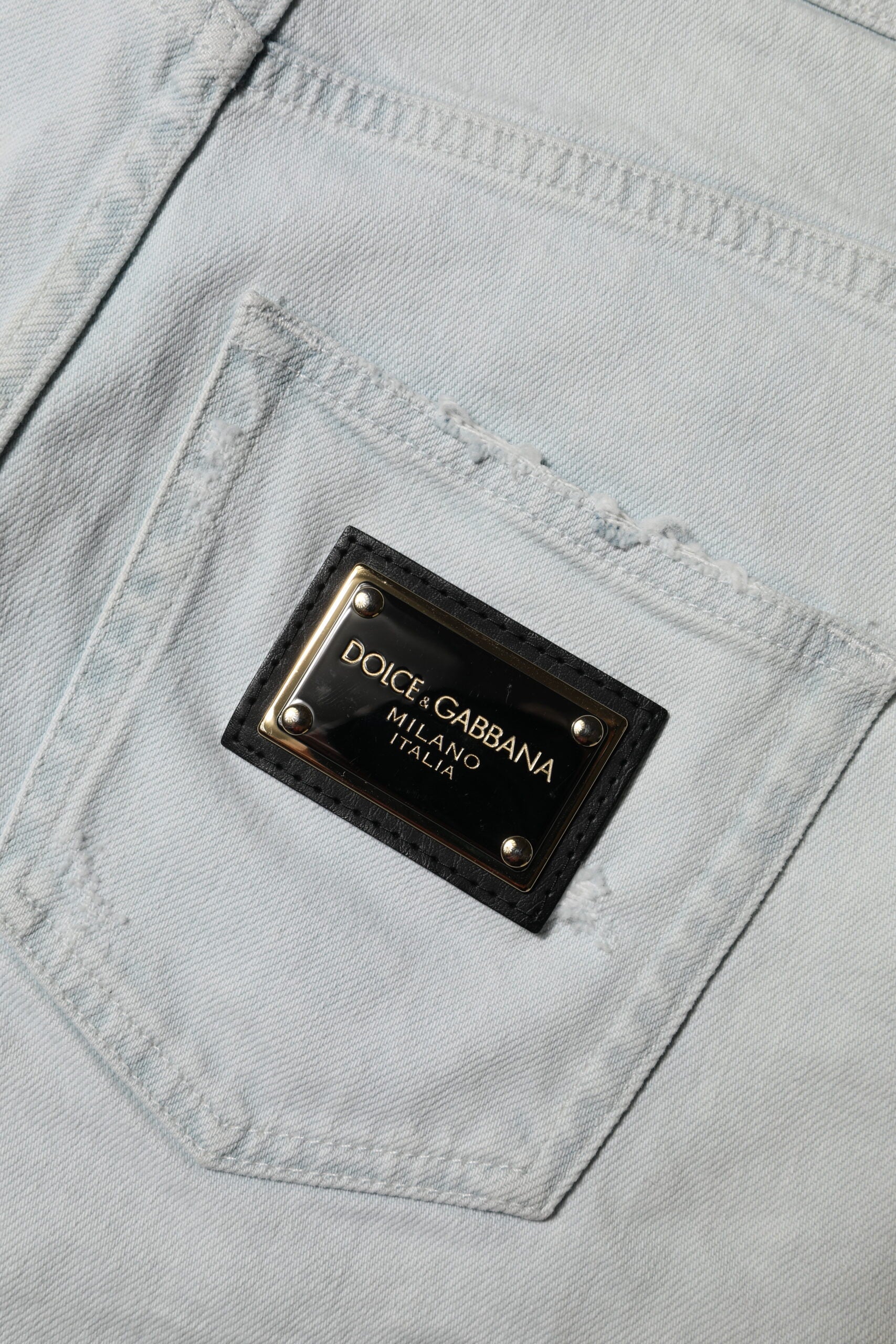 Pocket on blue jeans with black label