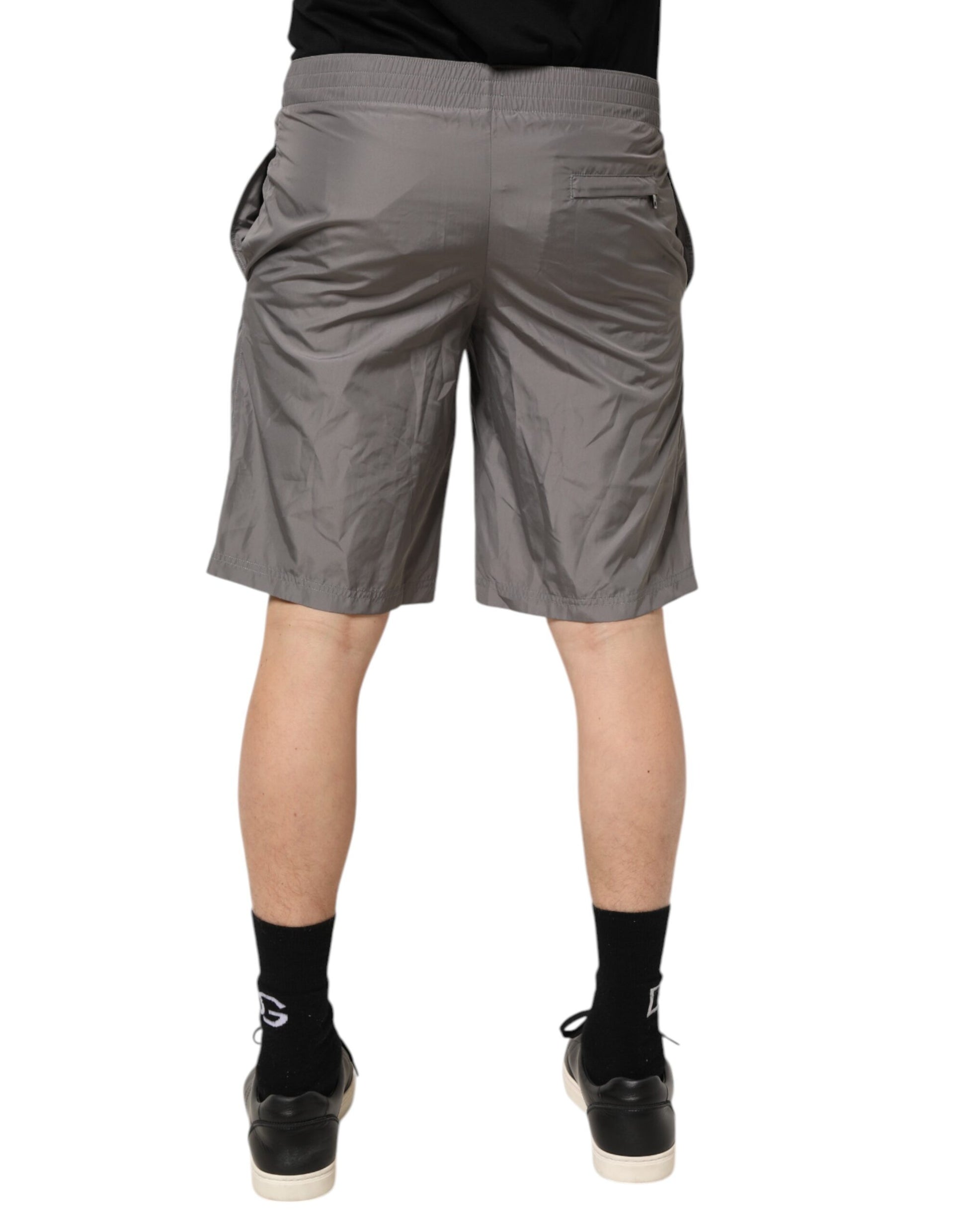 Man wearing gray shorts and black shoes
