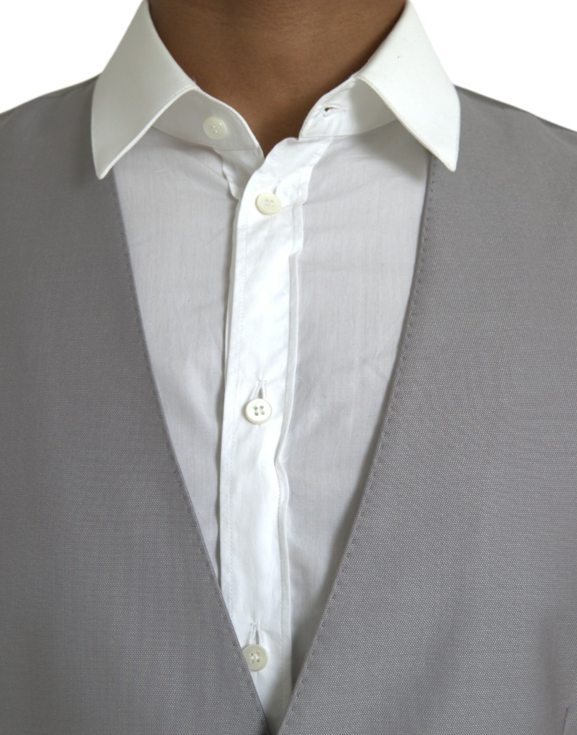 A light gray wool vest with white buttons, part of a formal dress ensemble