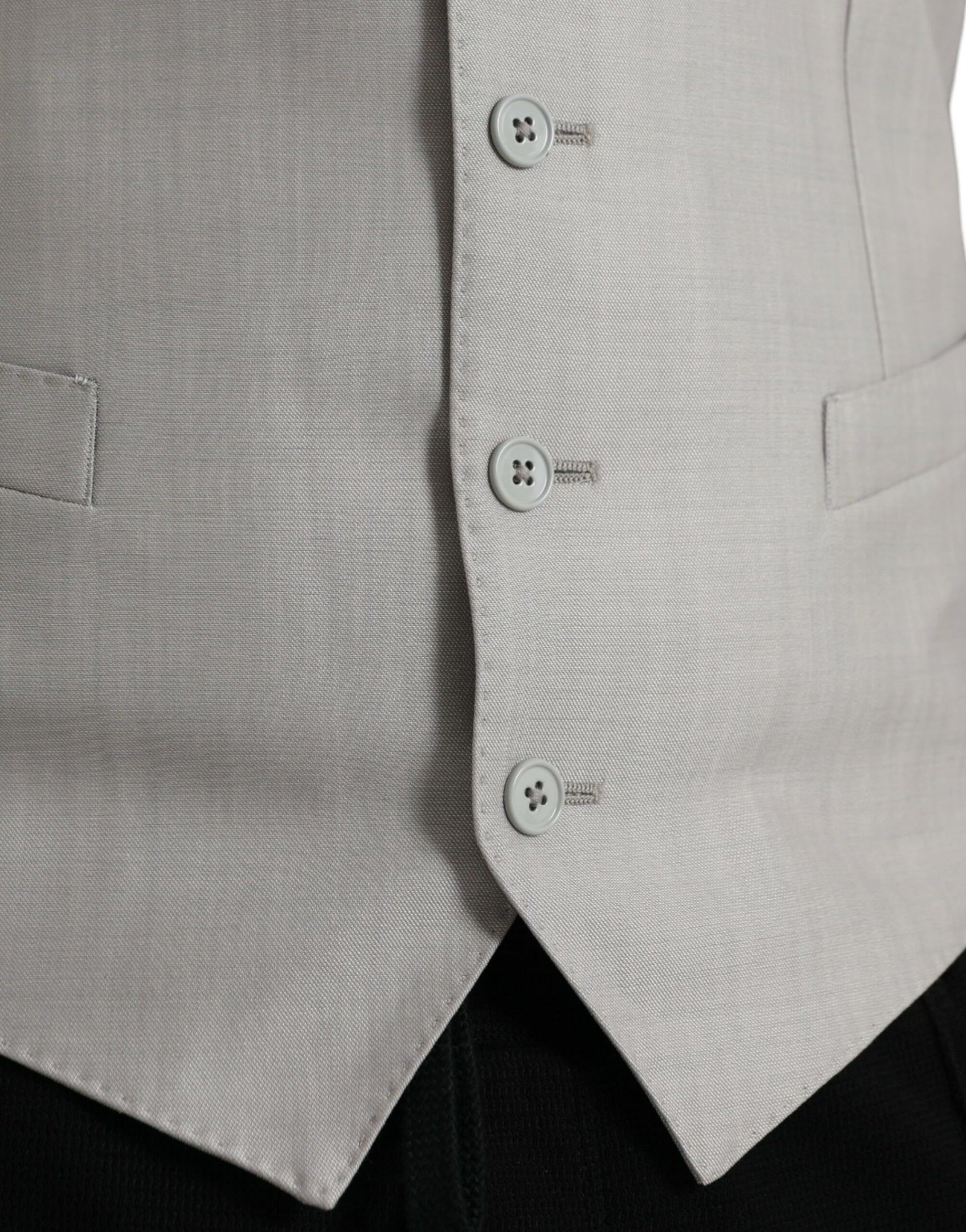 A light gray wool vest with black buttons and a lapel