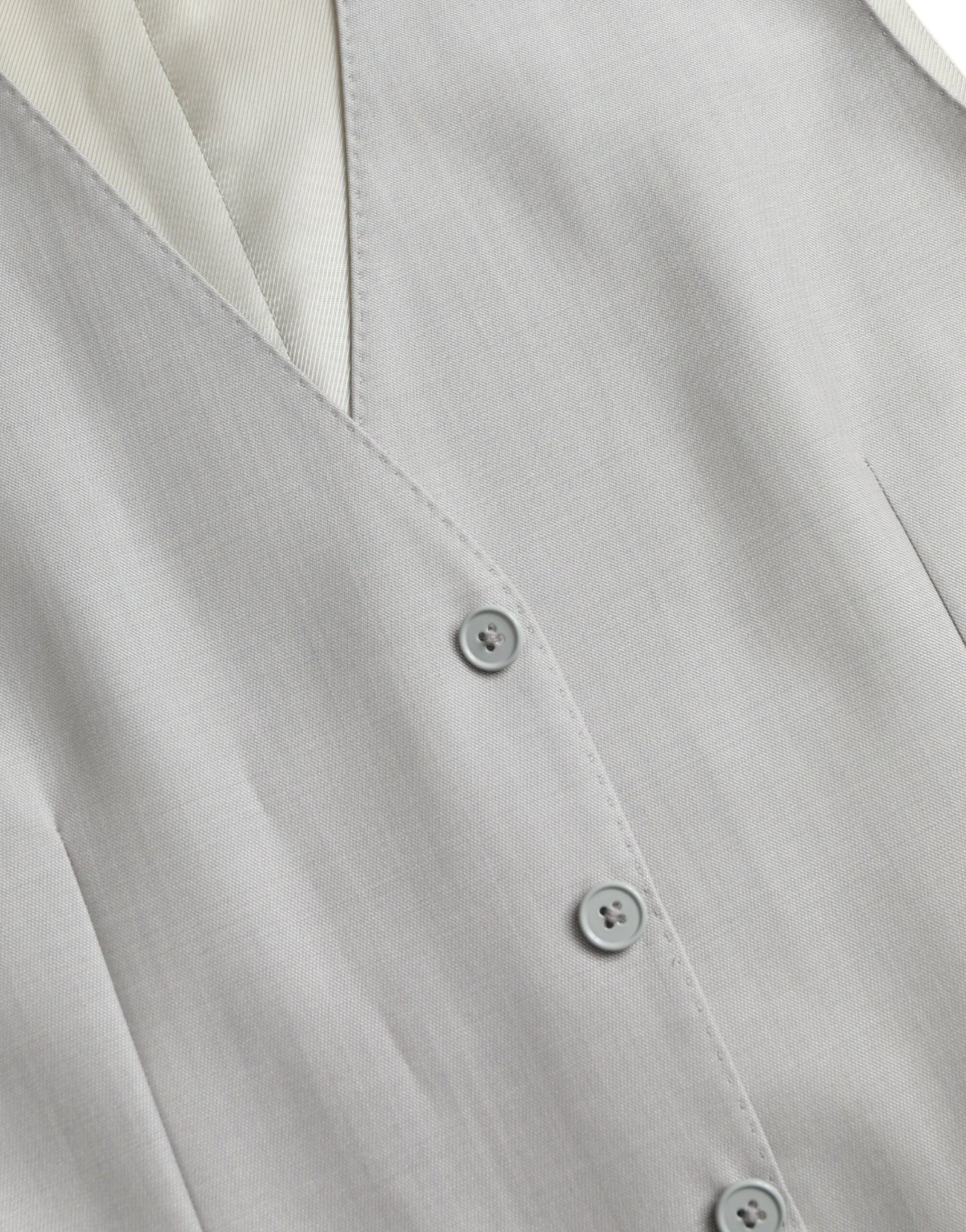 A light gray wool vest with a button front and two pockets