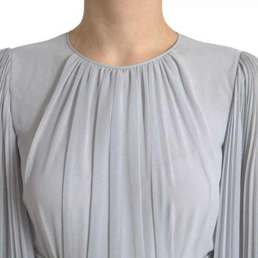 A long sleeved, light grey pleated maxi dress by Dolce & Gabbana