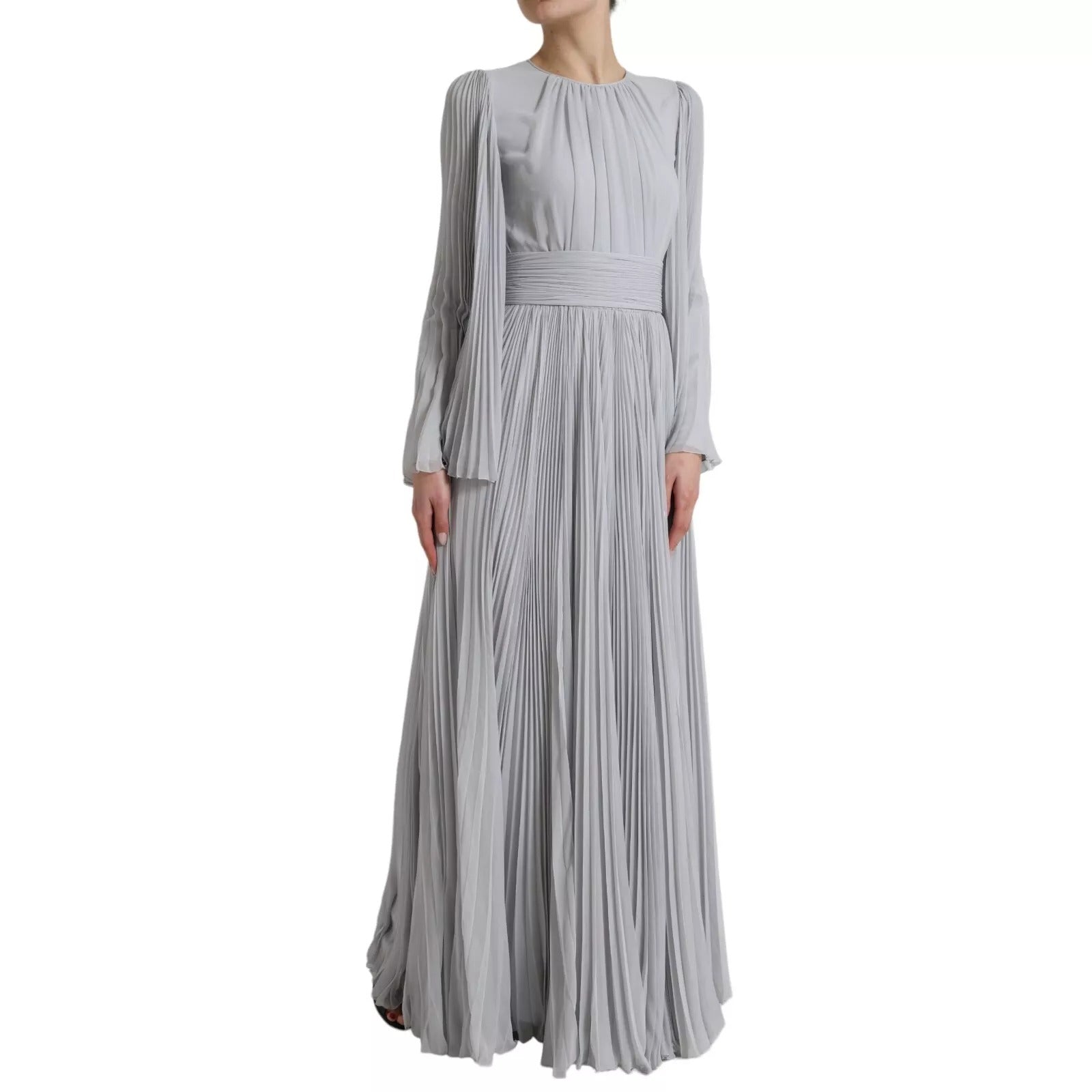 A long, light grey pleated maxi dress with a V-neckline and three-quarter length sleeves