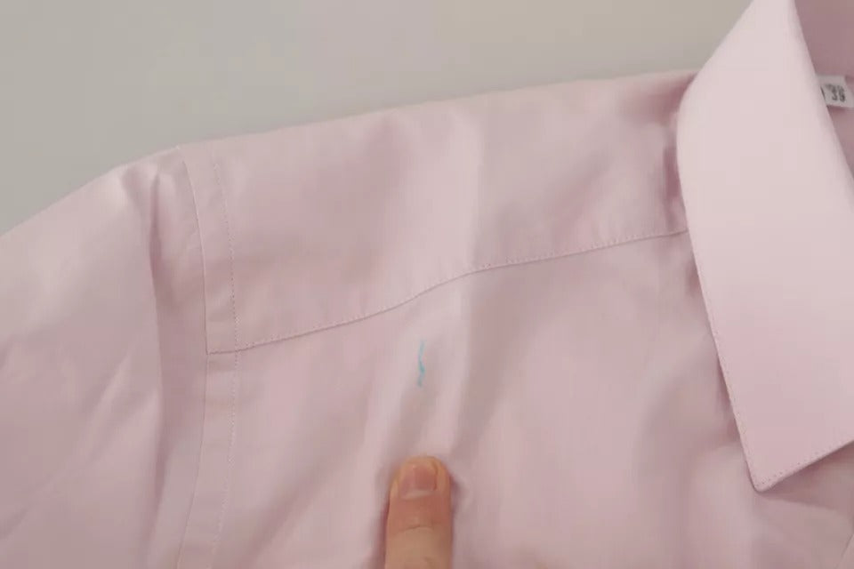 A light pink cotton dress shirt with a gold collar and cuffs