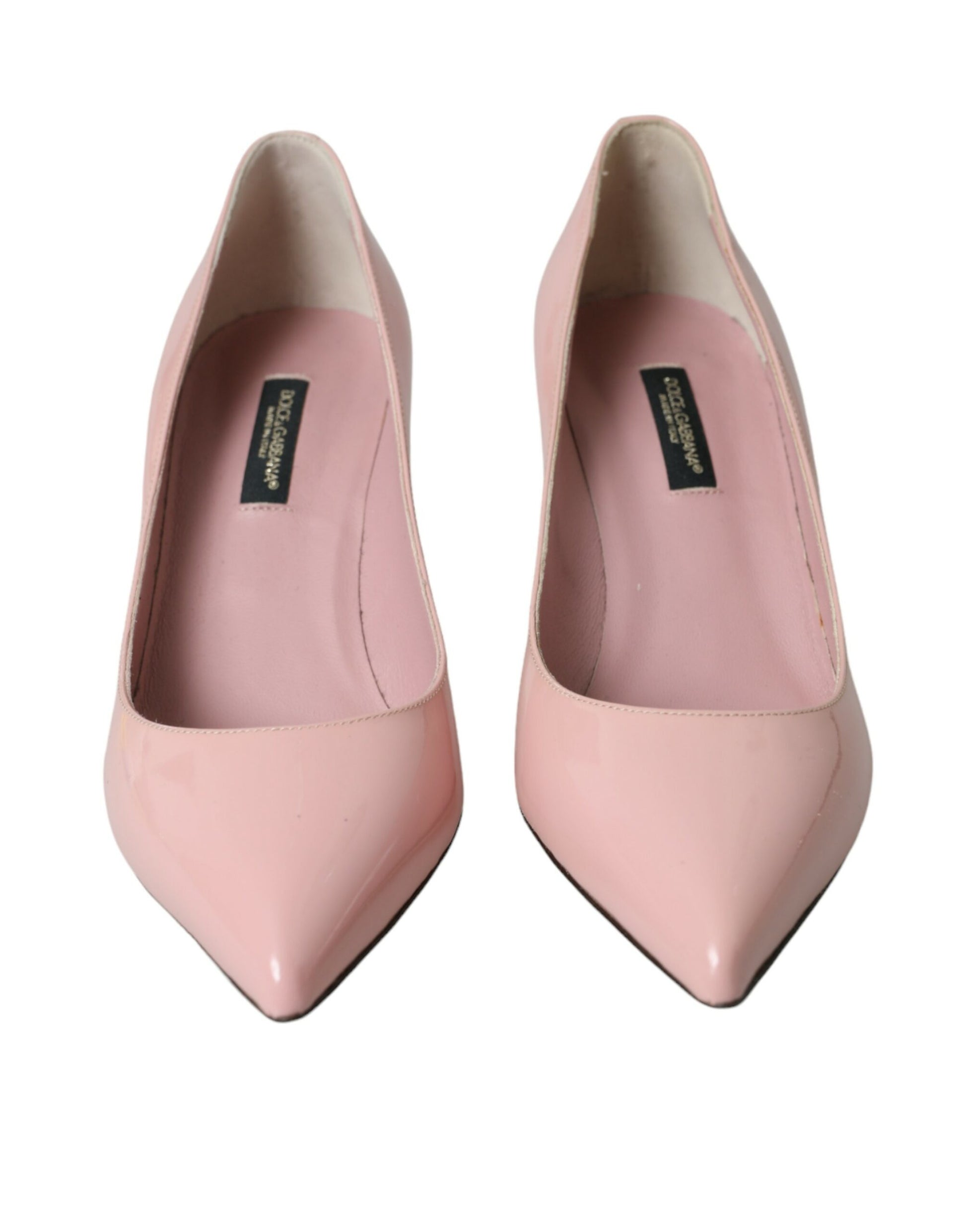 Pair of pink high heel shoes with a bow on top