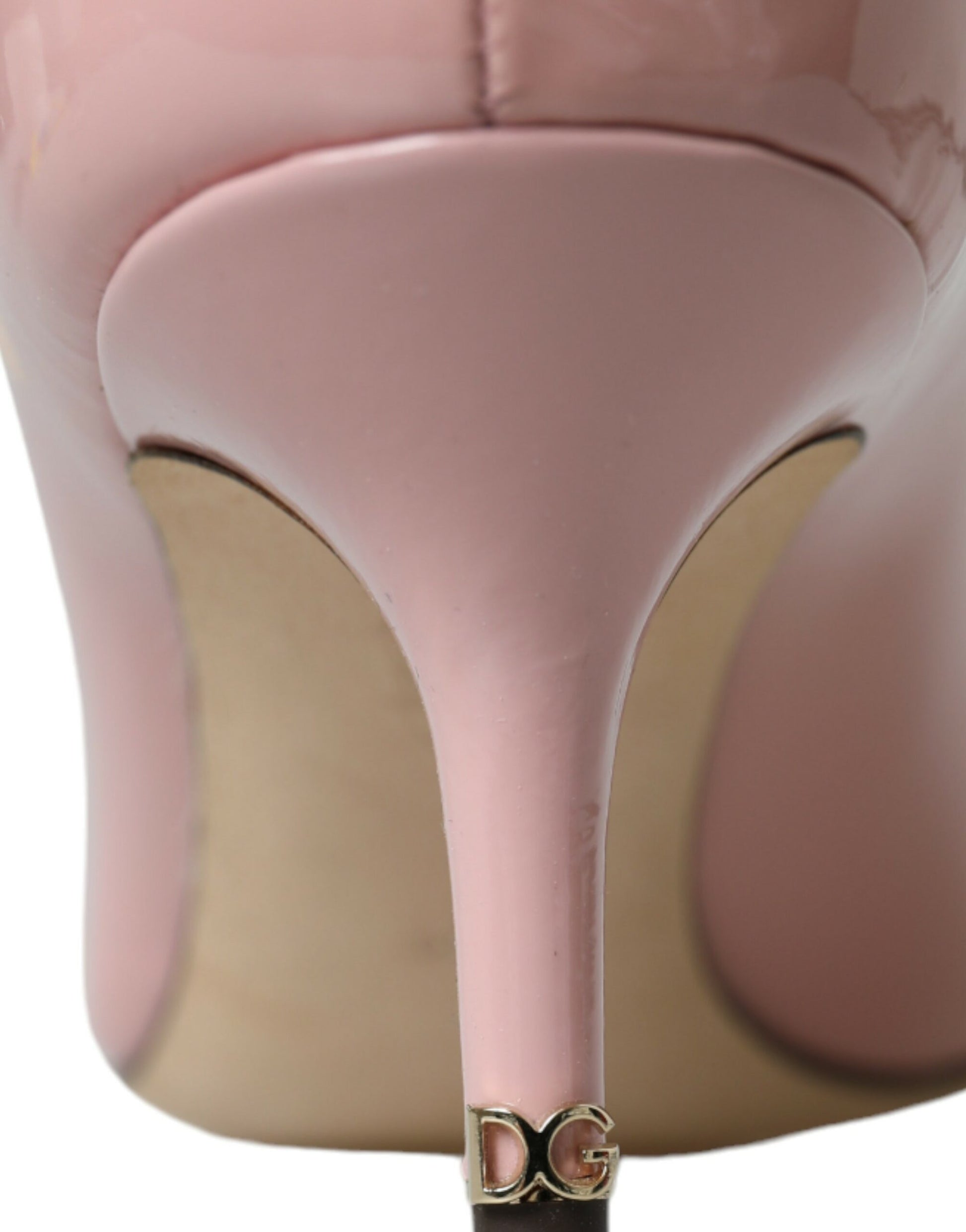 Pink high heel shoe with gold buckle on toe