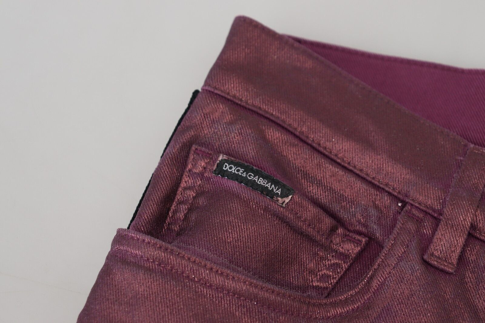 Pair of burgundy velvet jeans with a small label on the waistband