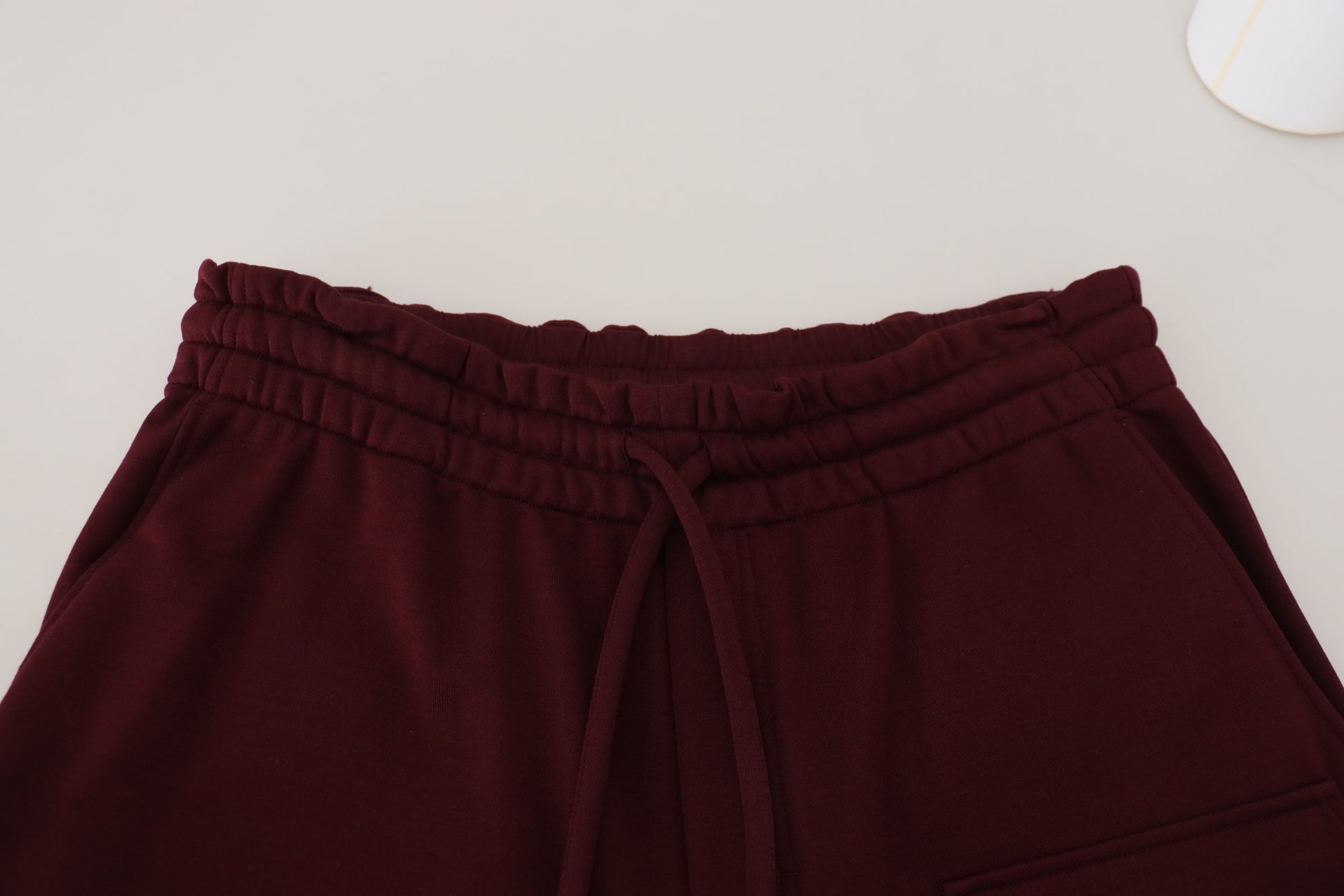 Pair of maroon sweatpants with elastic waistband