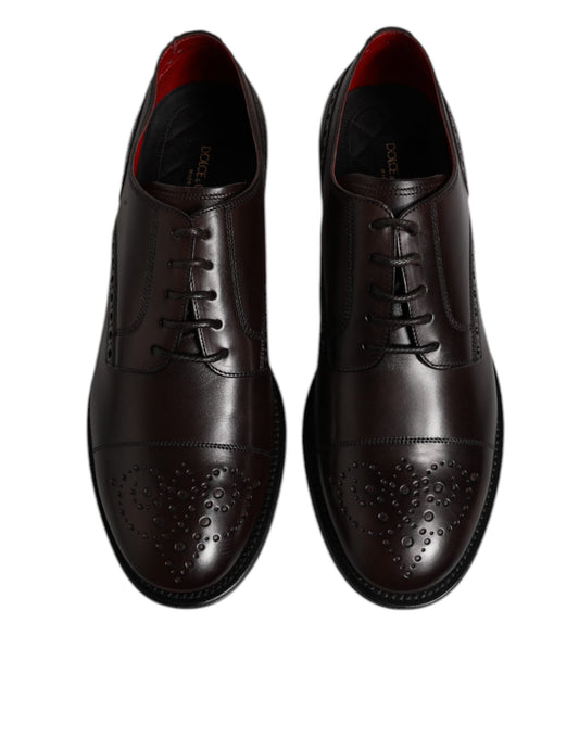 Pair of men's dress shoes, maroon calfskin leather, laced up with silver eyelets and tonal stitching