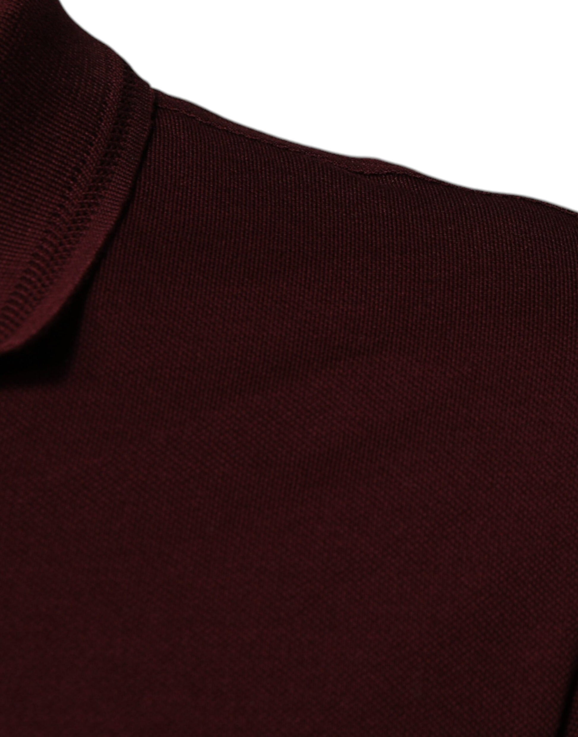 A maroon sweater against a white background