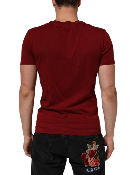 Man wearing red shirt and jeans with floral design on back
