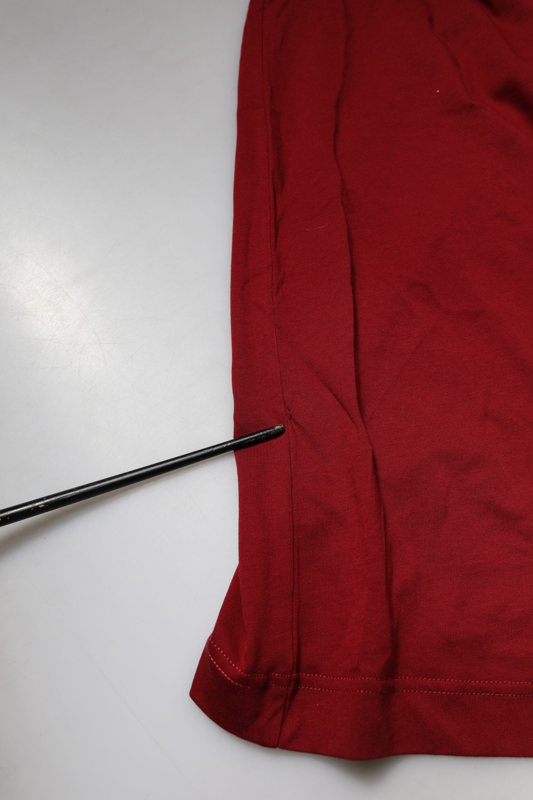Red fabric with a black line drawn on it