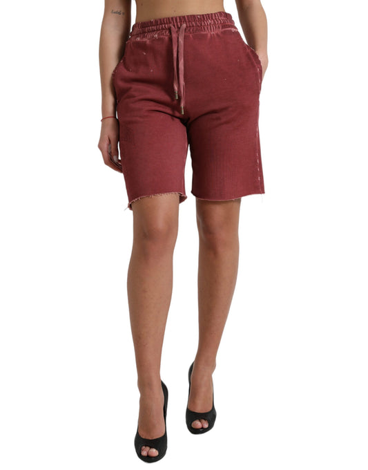 Woman wearing red shorts with rips on sides