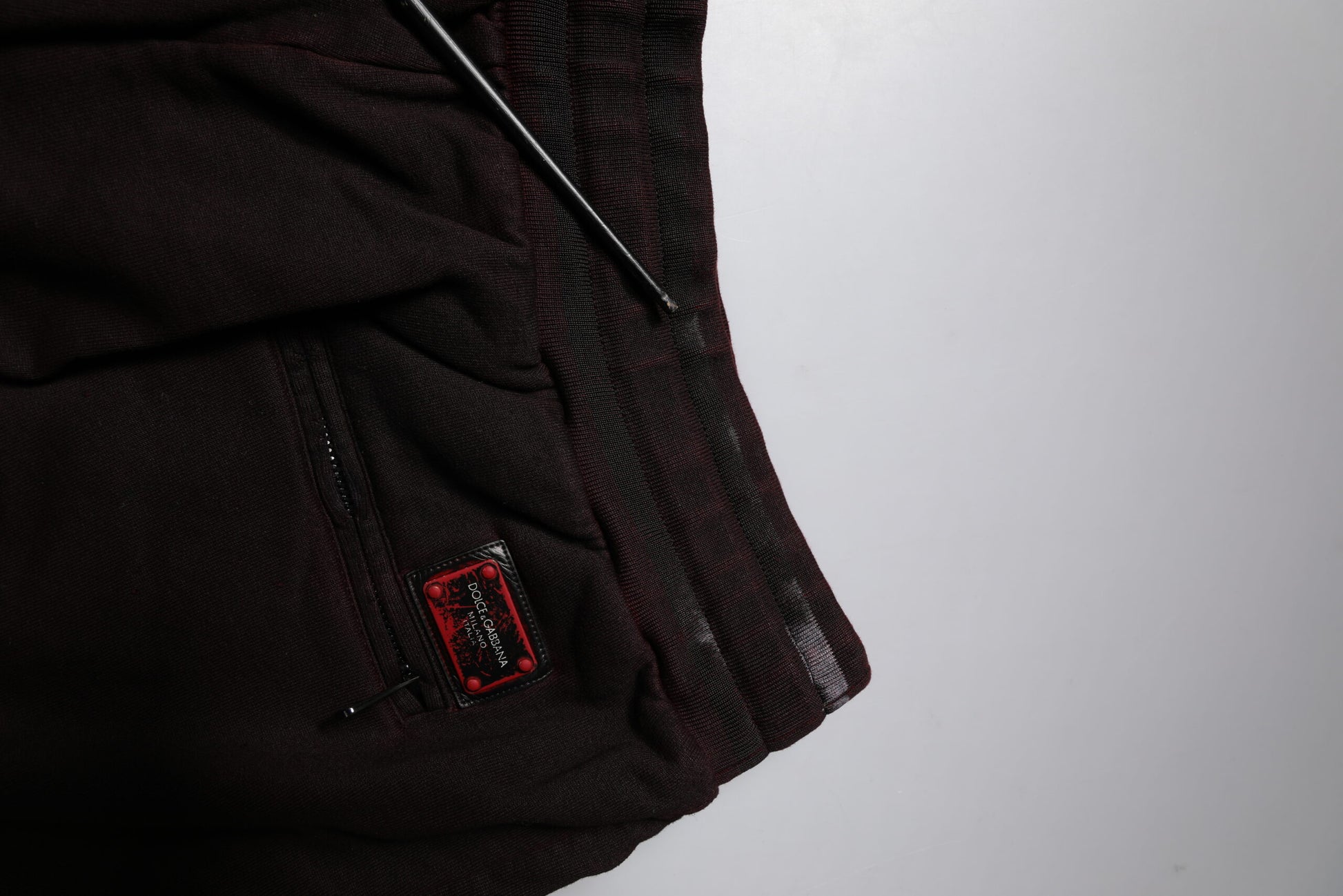Pair of black pants with a red label on the waistband
