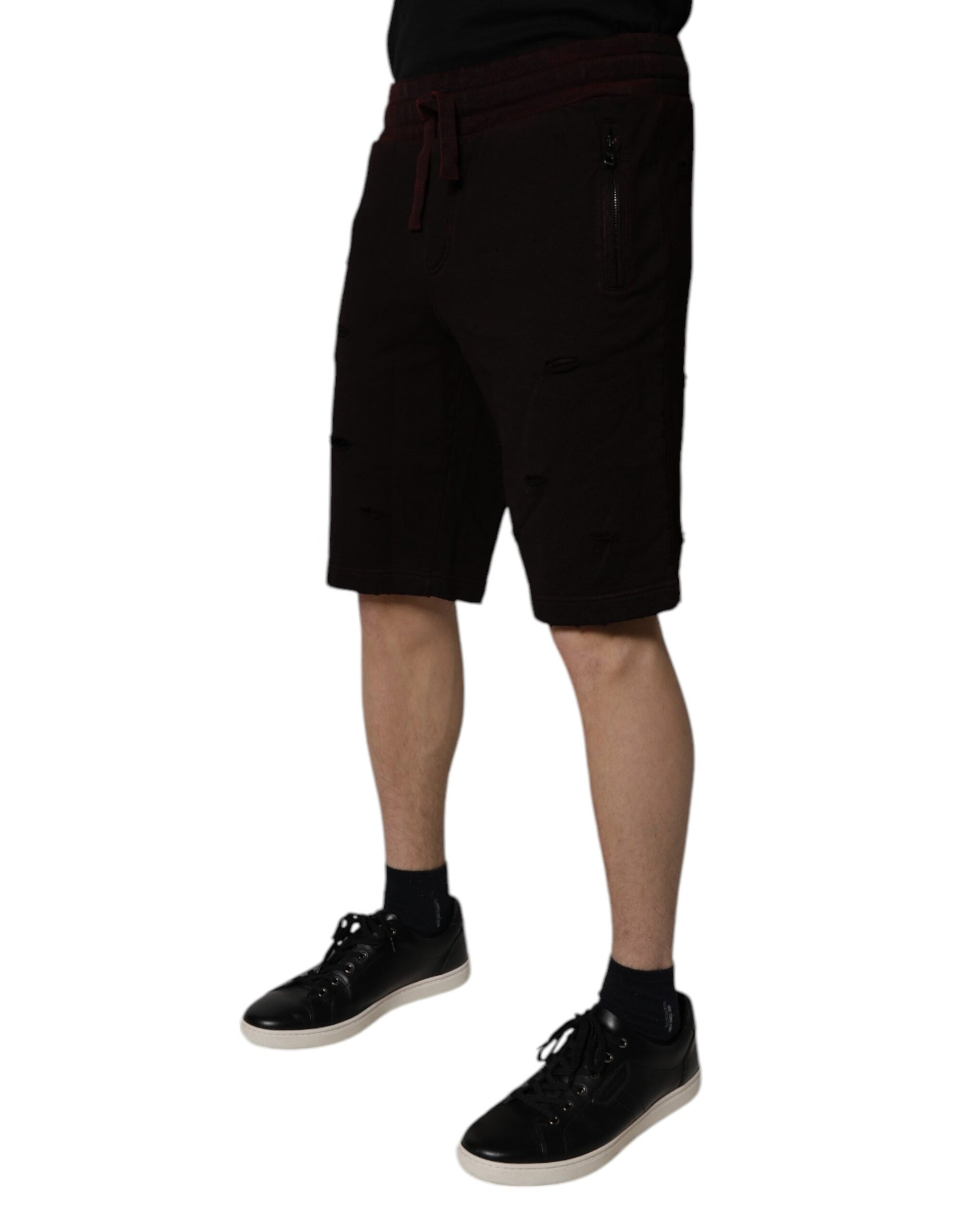 Man wearing black shorts and shoes