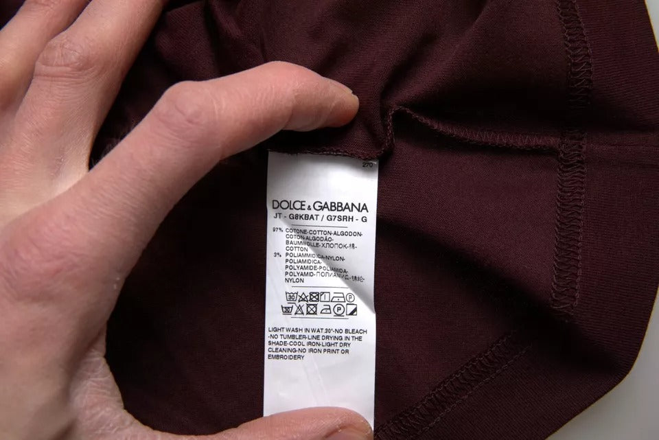 Hand holding a tagged piece of clothing