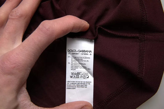 Hand holding a tagged piece of clothing