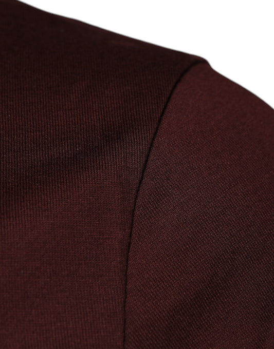 A close-up view of a maroon fabric item, possibly a garment or accessory, with a visible seam on the side
