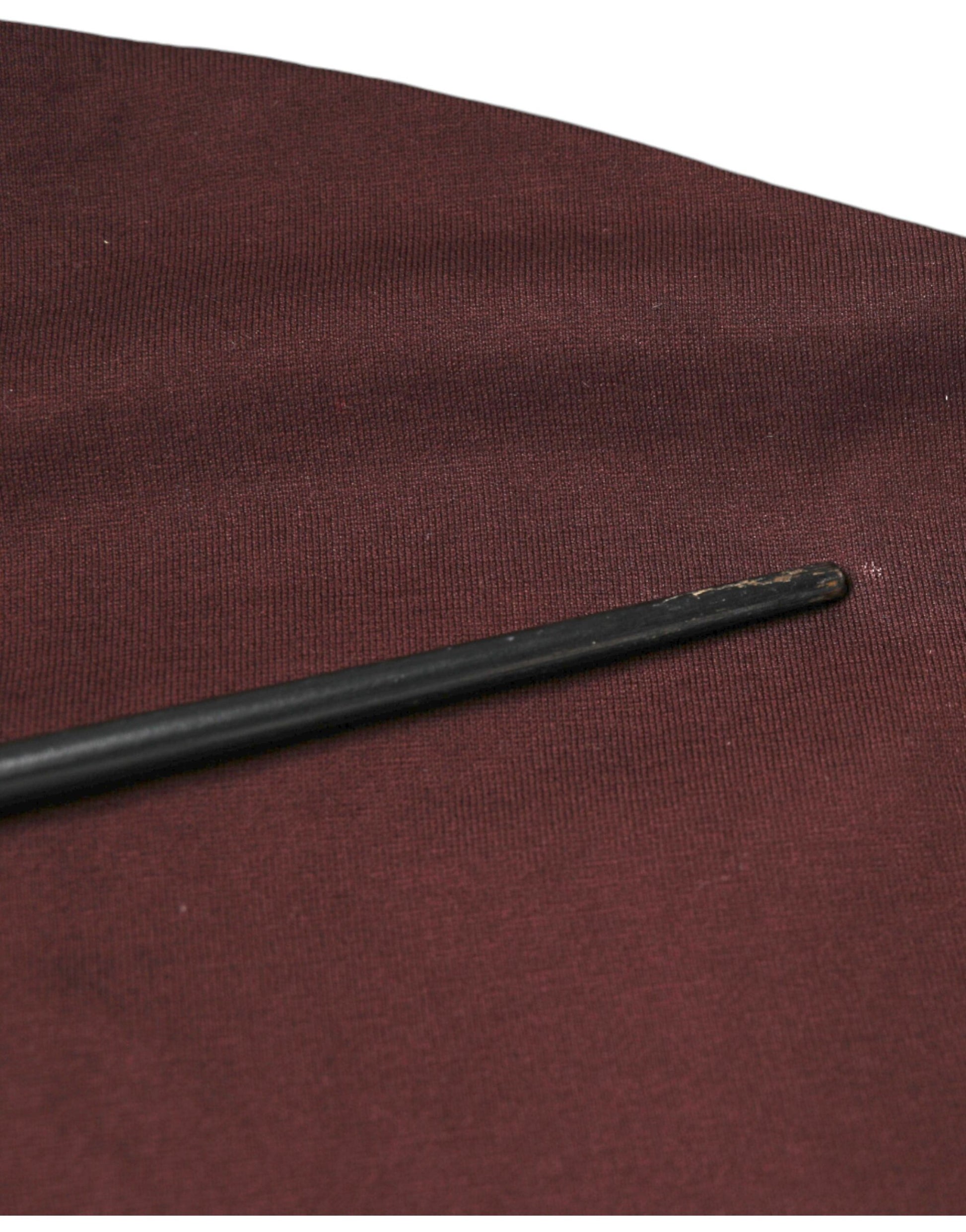 Black object on red fabric