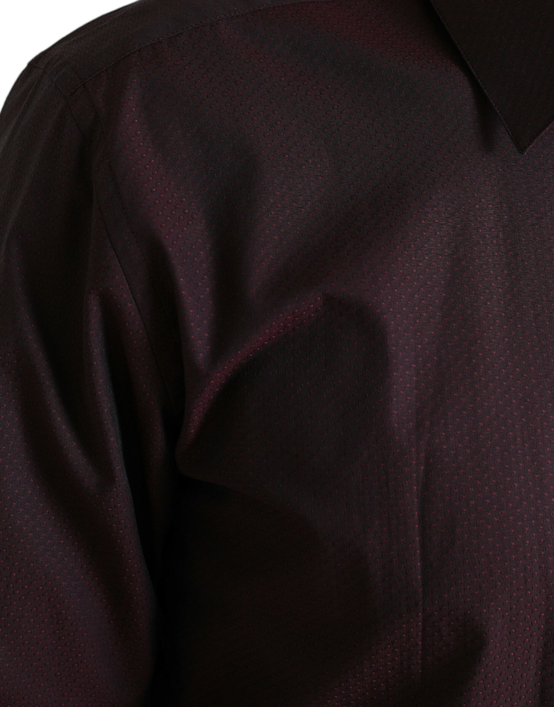 The shirt is dark red with a patterned texture