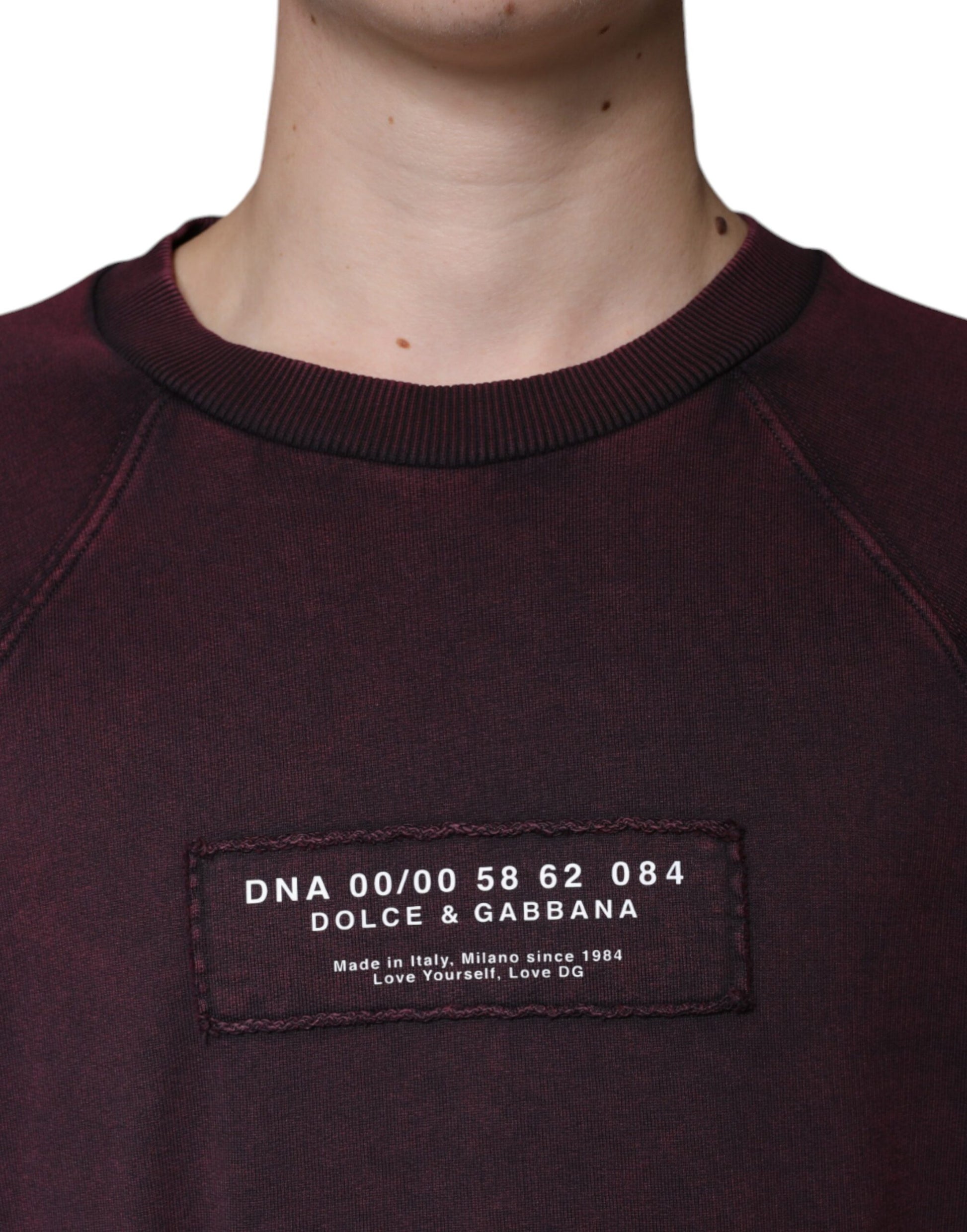Dark maroon sweatshirt with white lettering on front