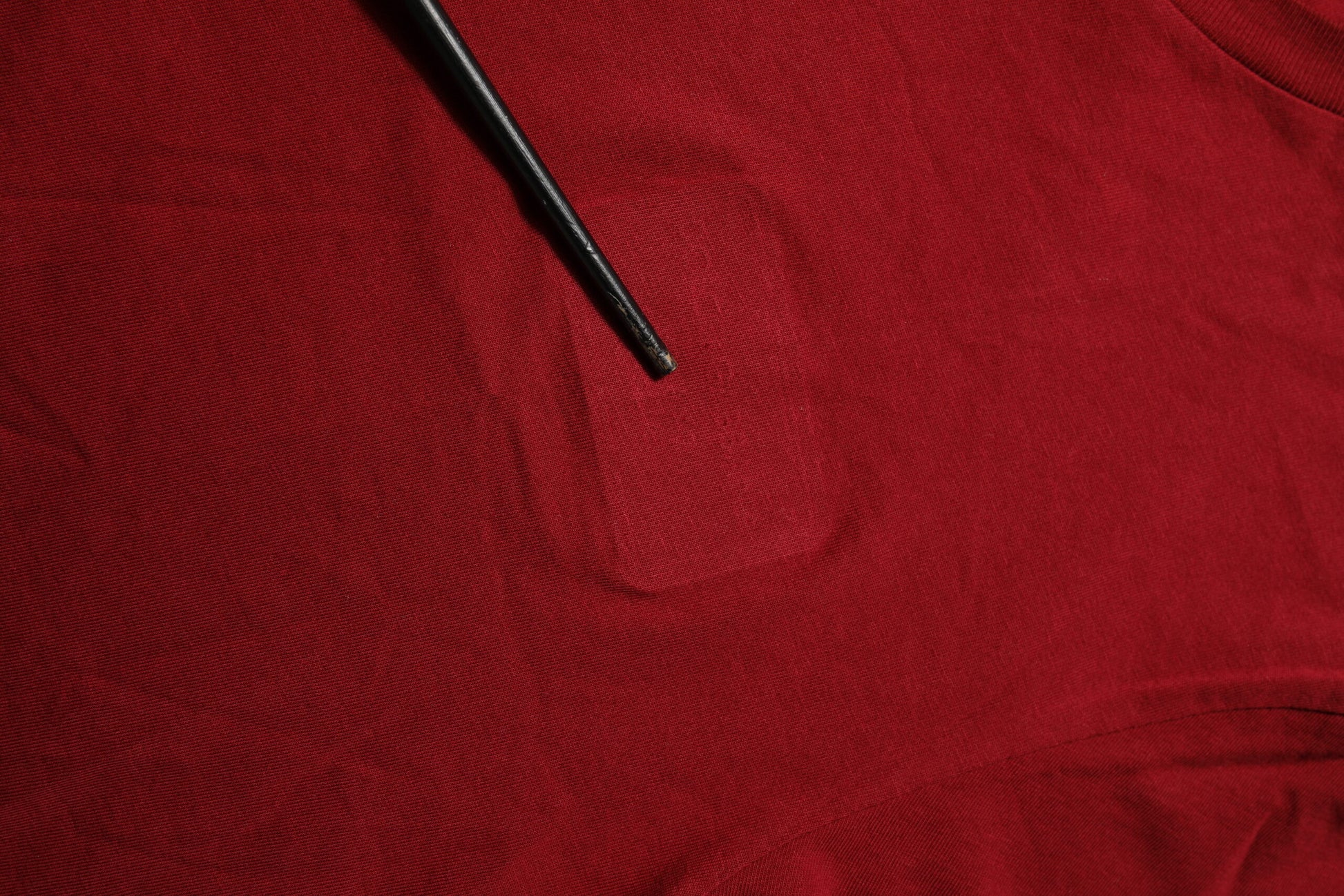 Red fabric with a hole in it