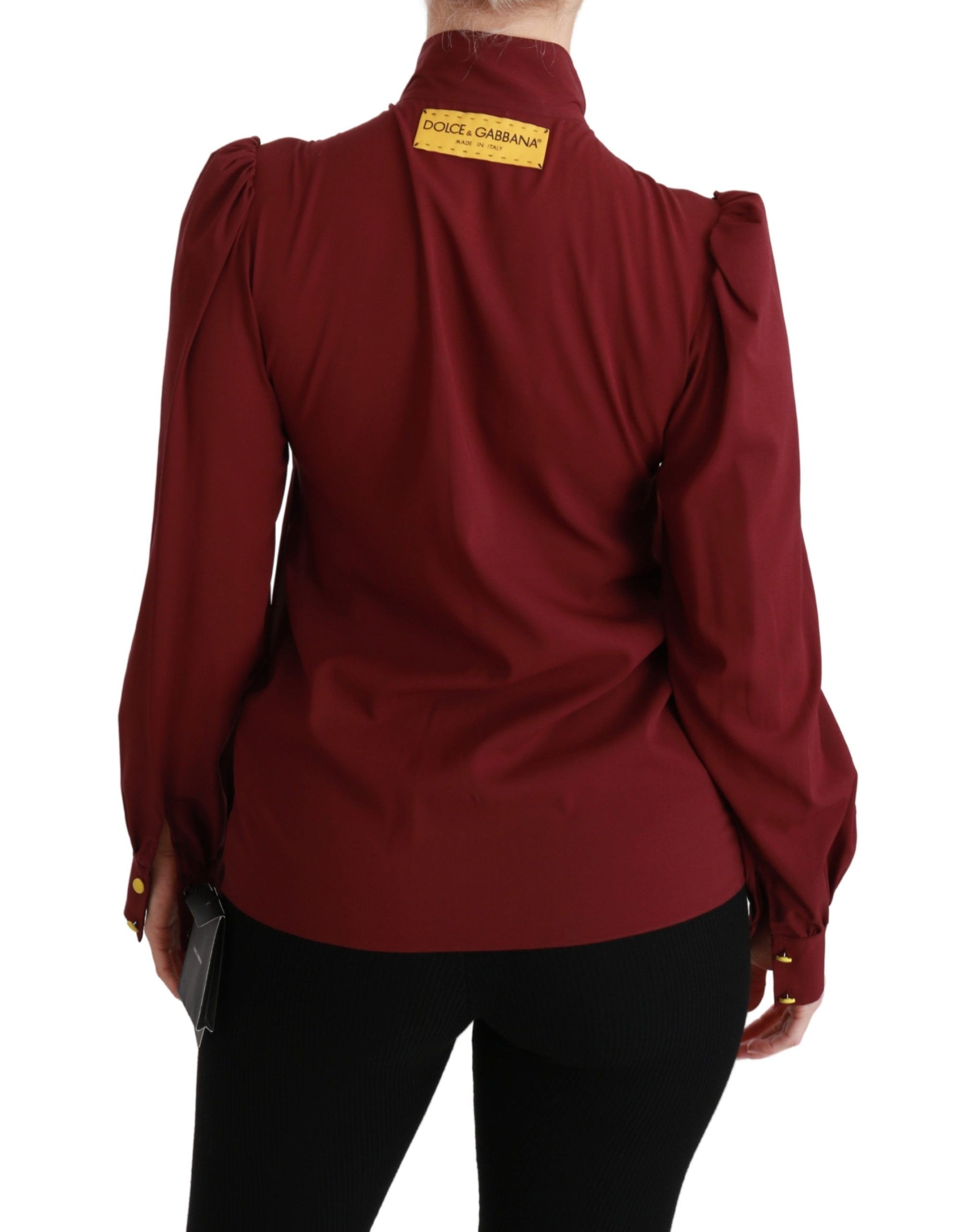 Woman wearing red blouse with yellow tag on back
