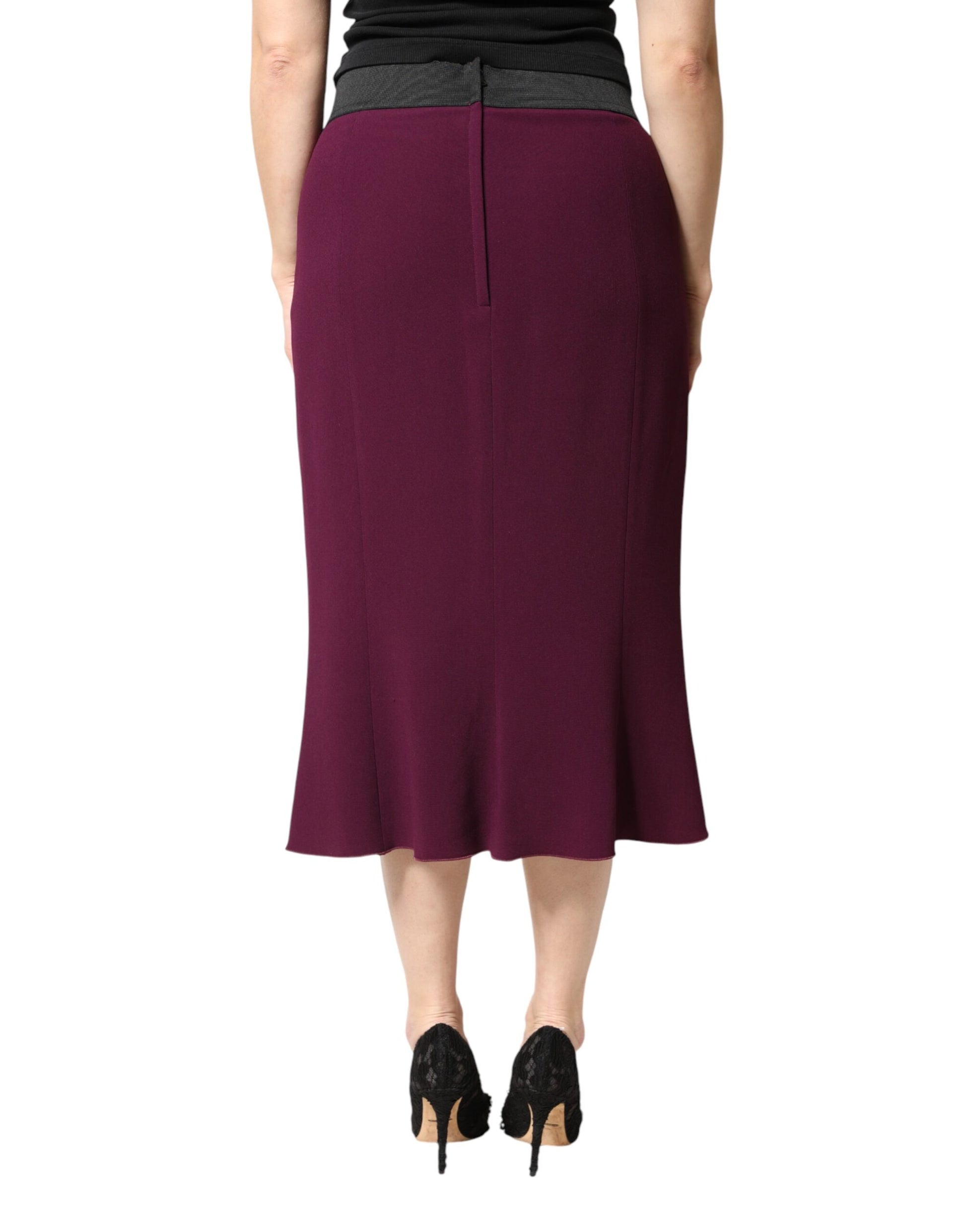 Woman wearing a maroon skirt and black heels