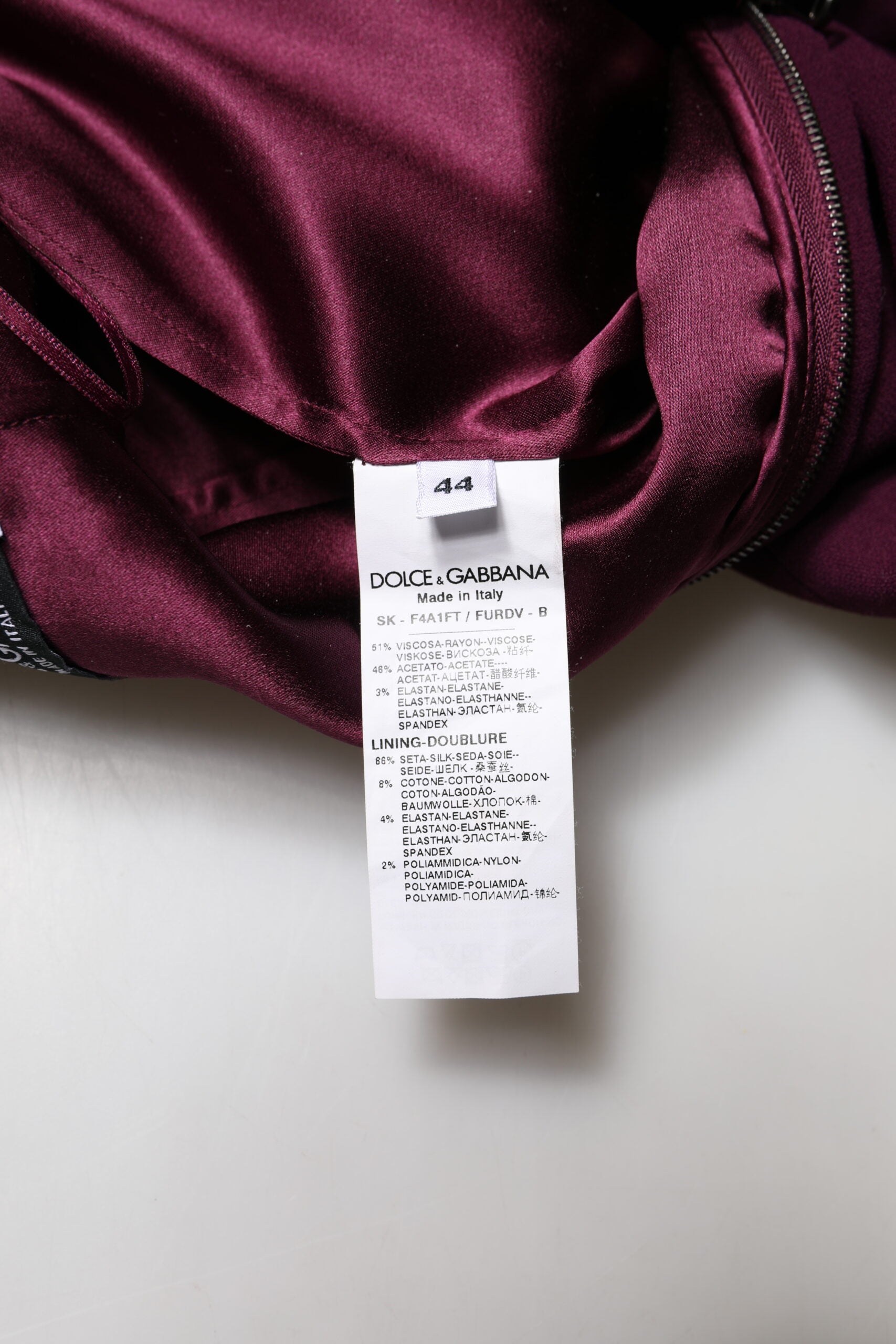 Purple fabric with tag attached to it
