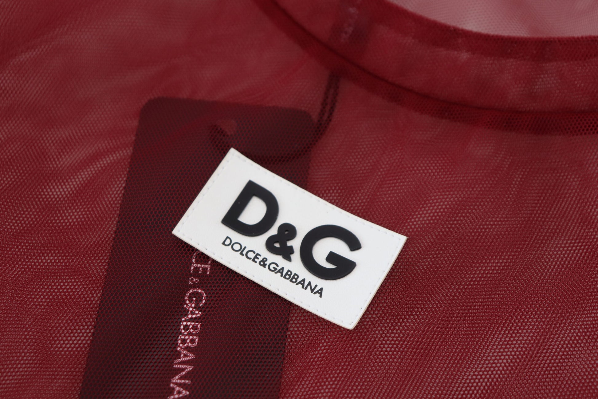 A maroon nylon two layer shift mini dress with a tag that reads "D&G Dolce & Gabbana"
