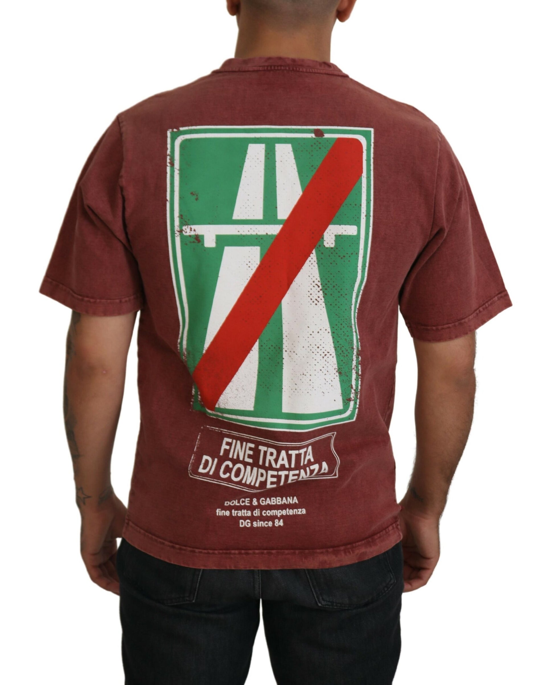 Man wearing red t-shirt with green and white logo
