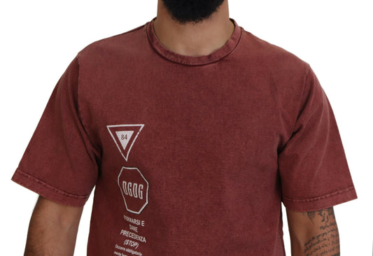 Man wearing maroon t-shirt with white graphic on front