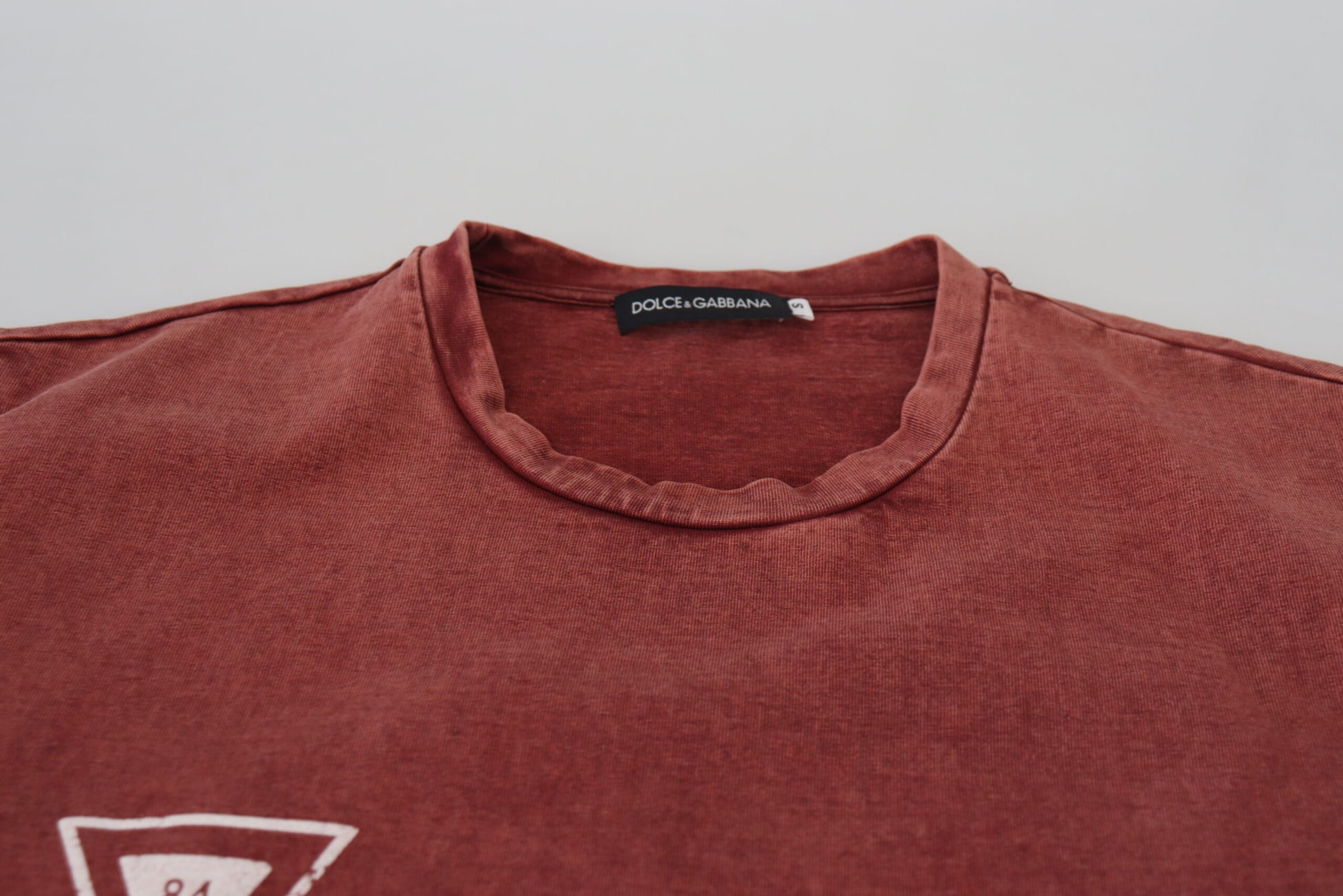 Red short sleeve shirt on hanger