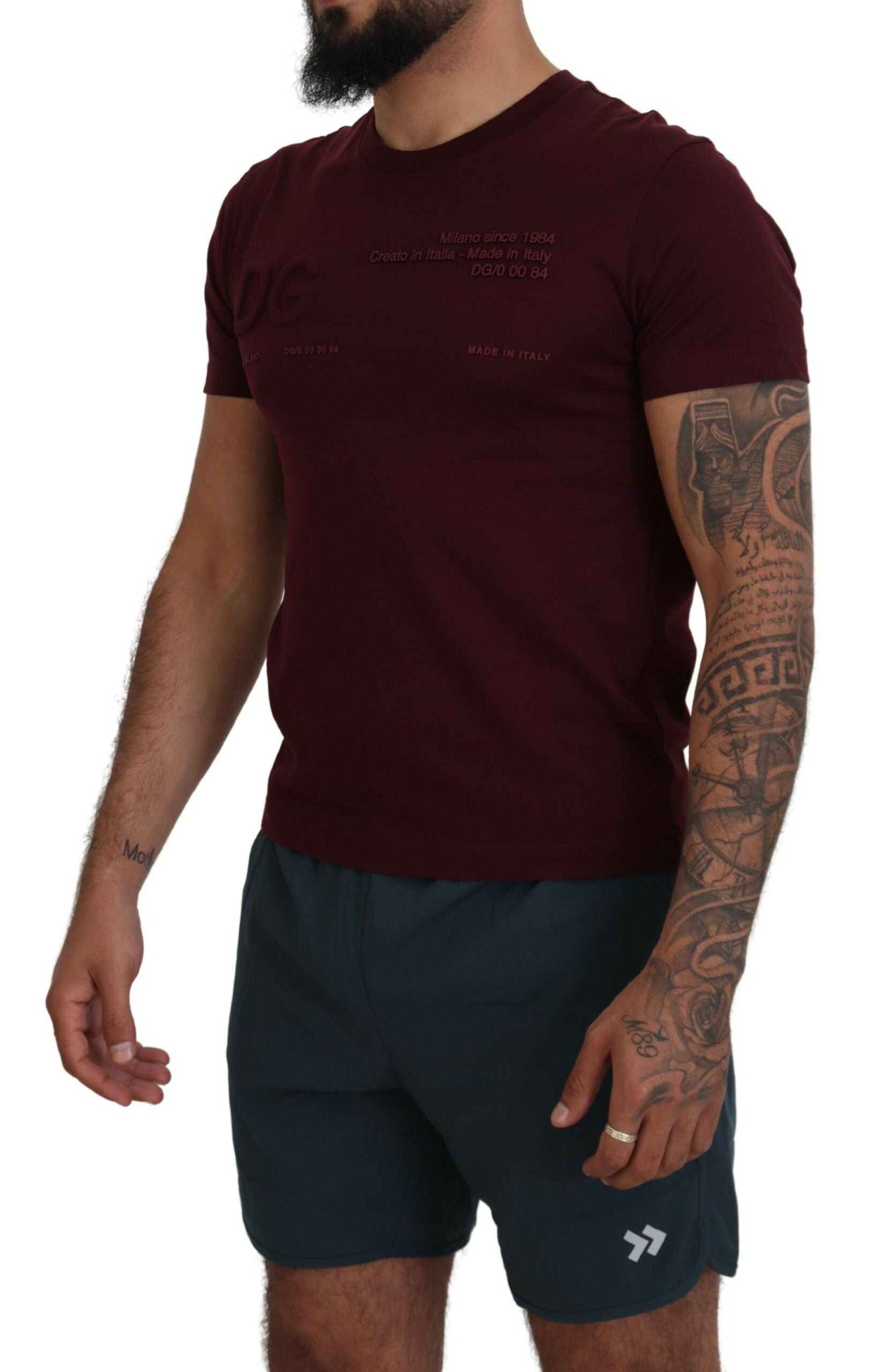 Man wearing maroon t-shirt and black shorts
