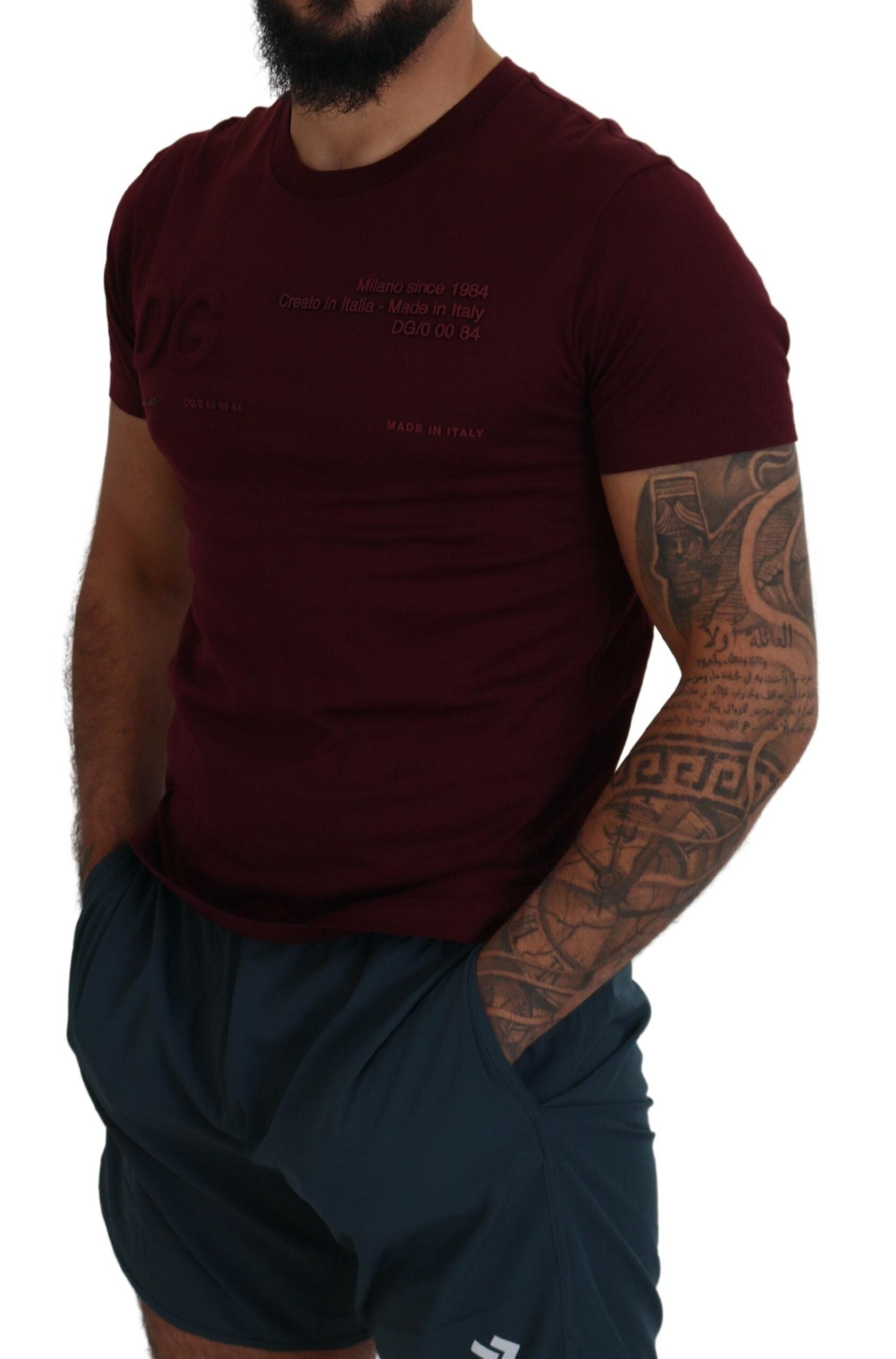 Man wearing maroon t-shirt and black shorts