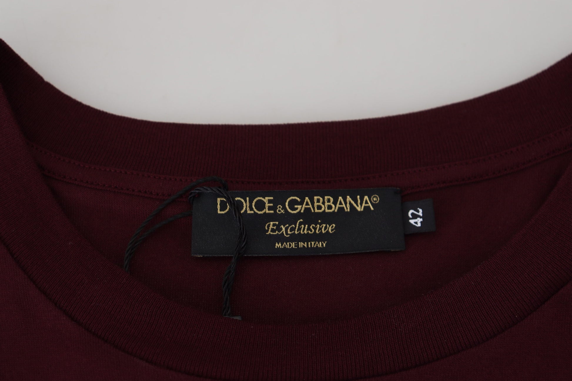 The tag is black with gold lettering