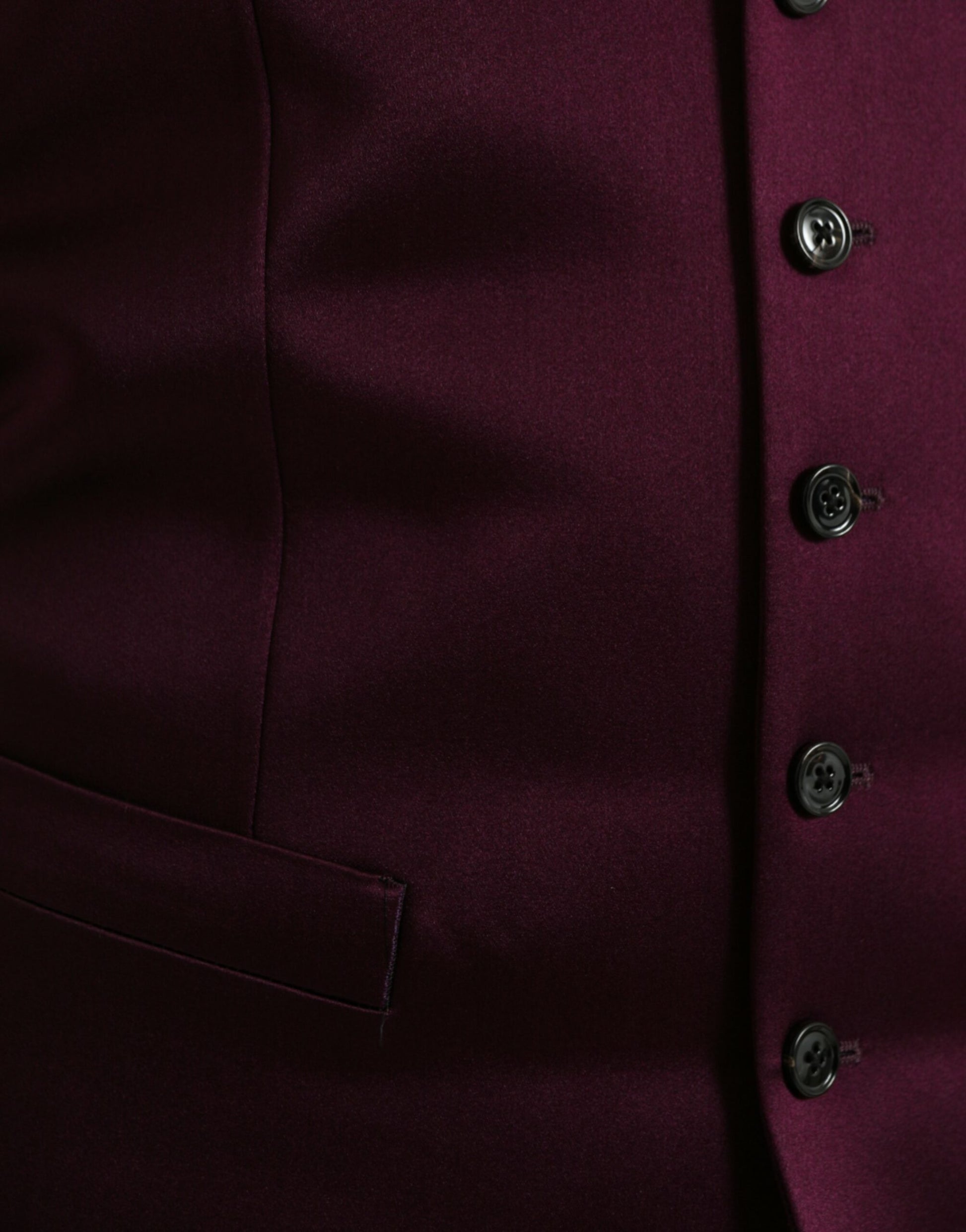 A maroon satin silk waistcoat with black buttons