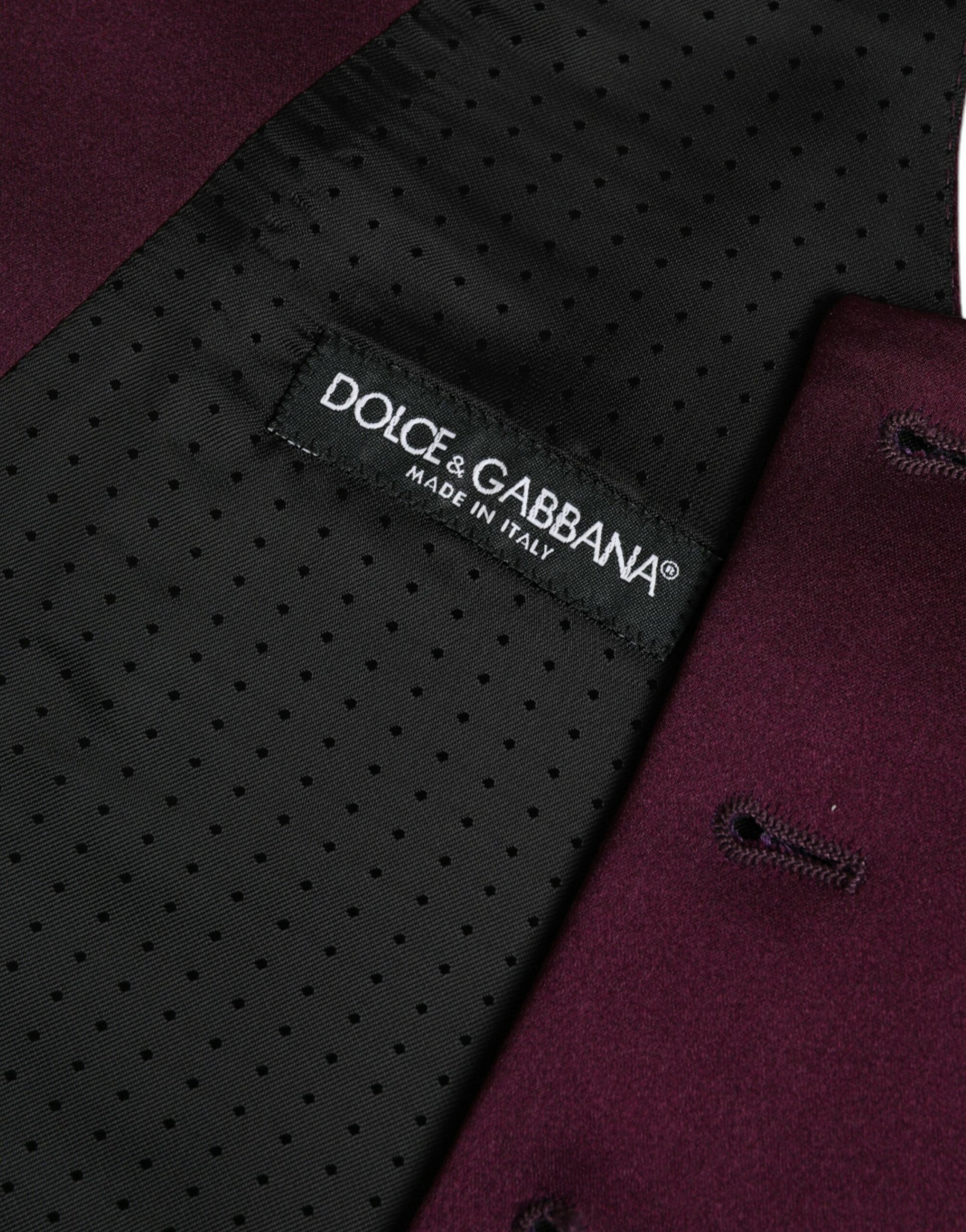 A maroon satin silk waistcoat with a label that reads "Dolce & Gabbana"