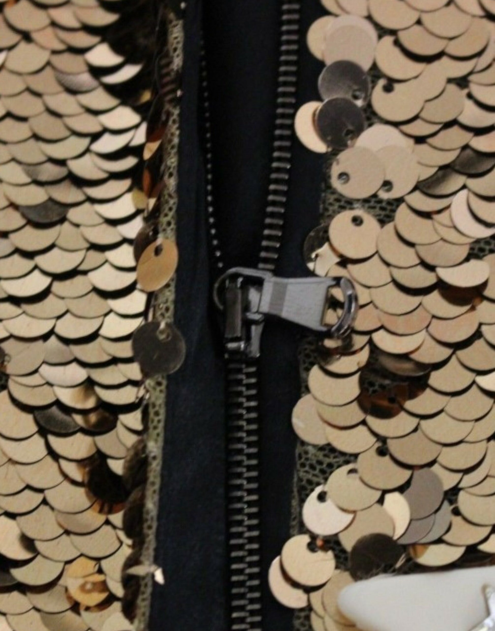 Gold sequined garment with zipper closure