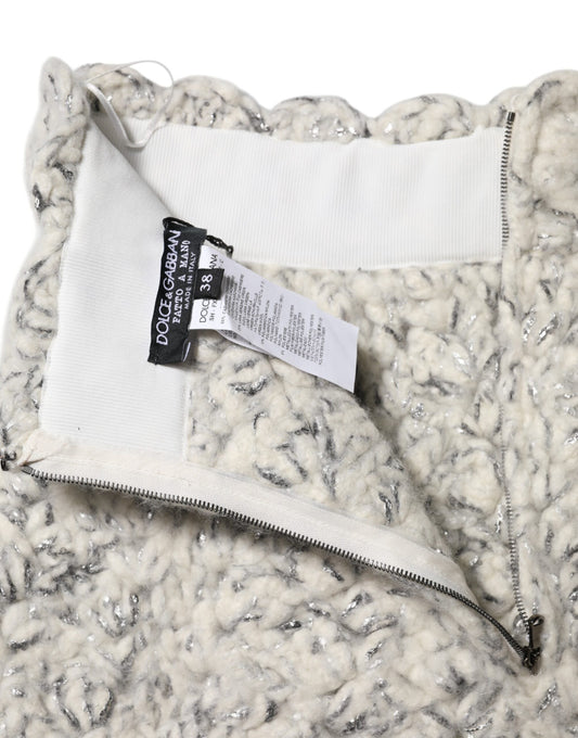The jacket is white and gray with a zippered front