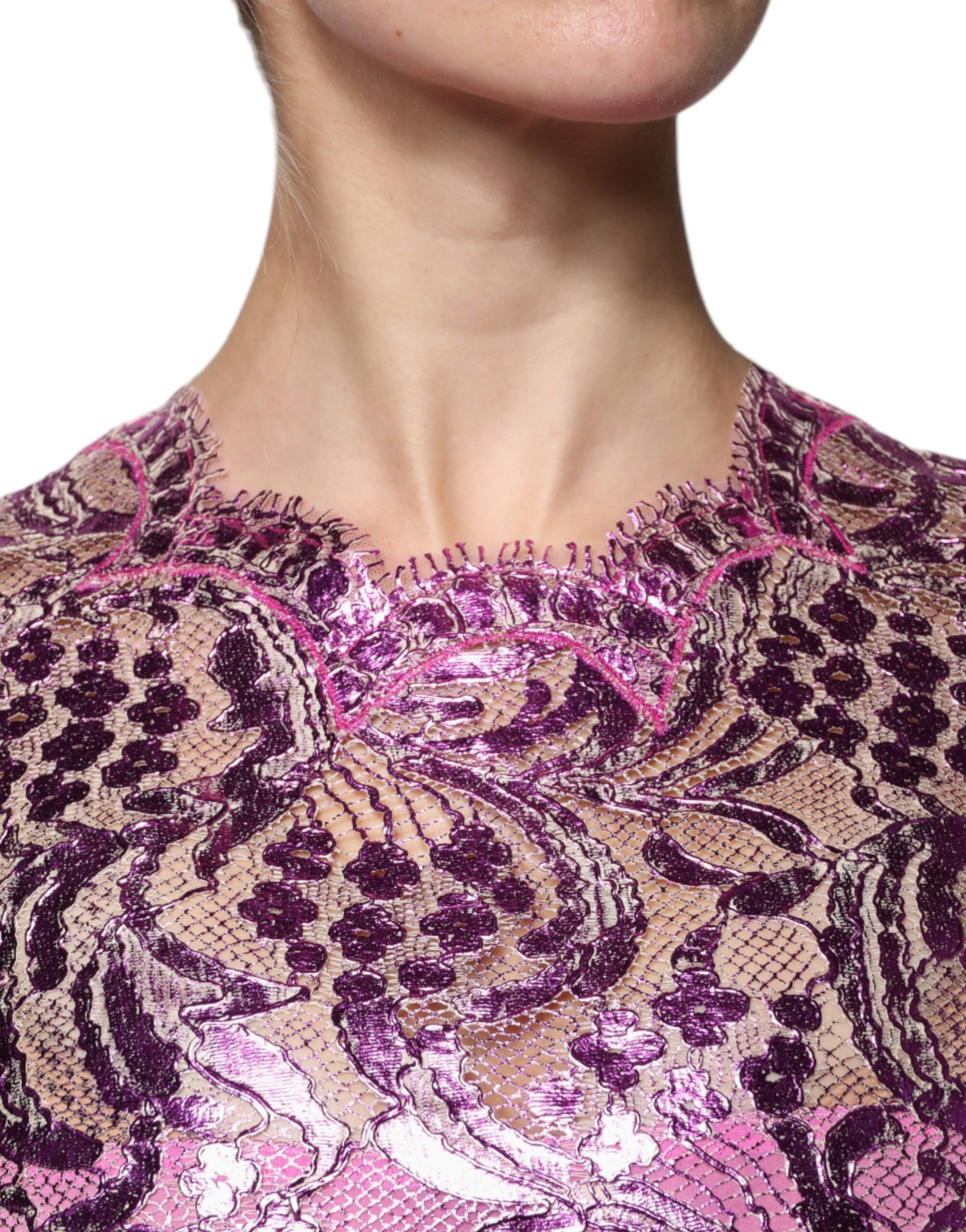 A woman wearing a metallic fuchsia floral sheath mini dress