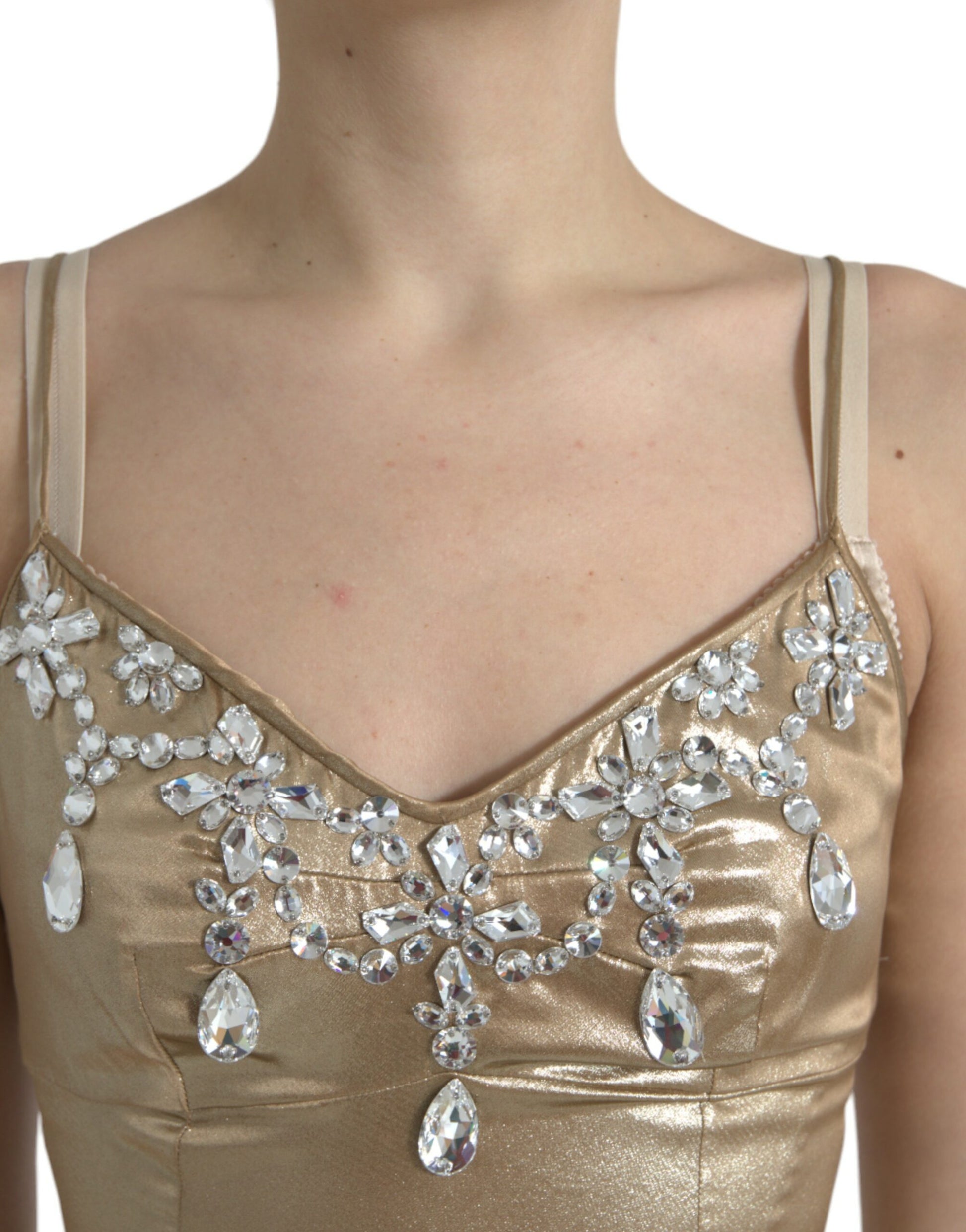 A gold dress with crystal embellishments on the bodice and sleeves