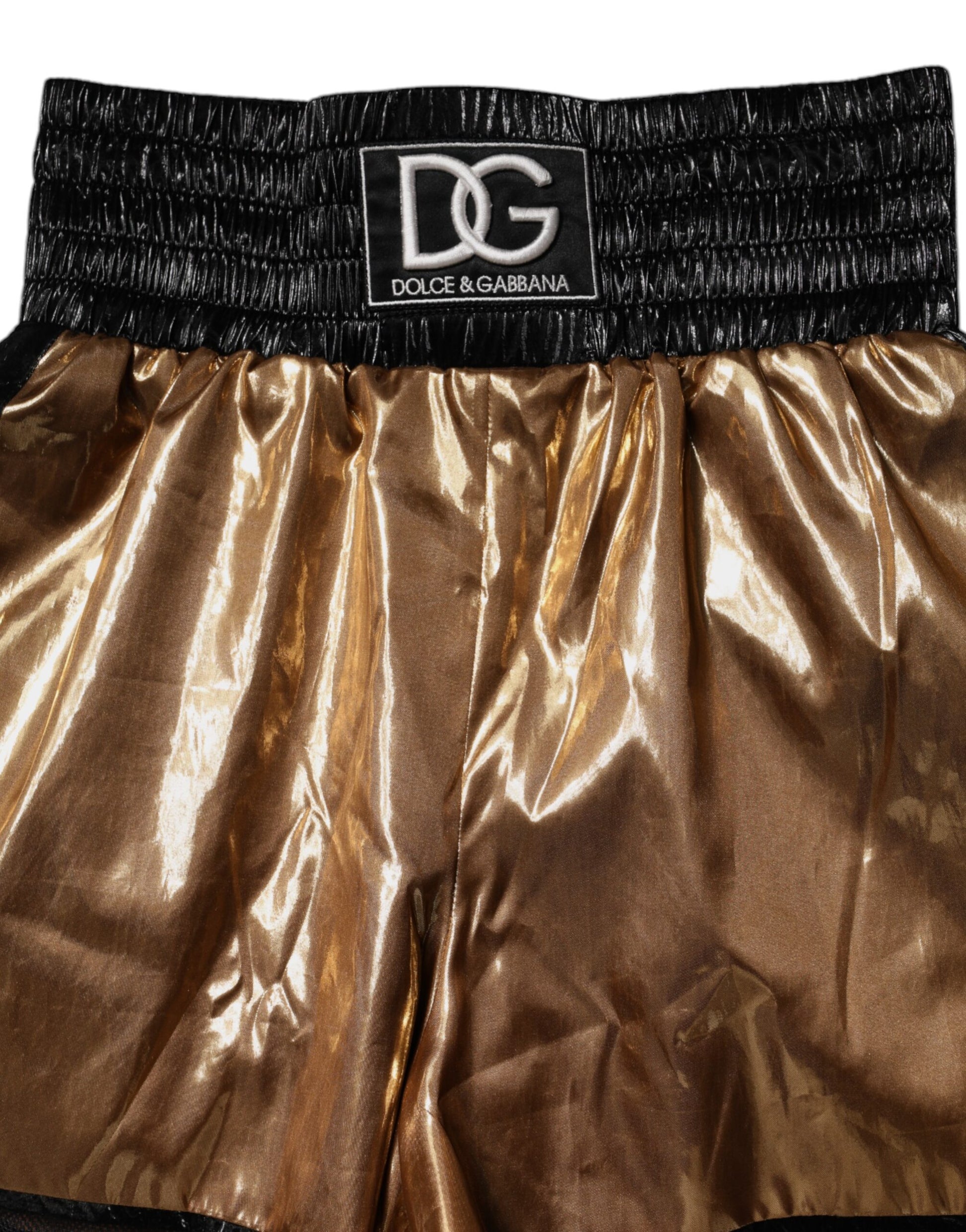 Pair of gold boxing shorts with black trim